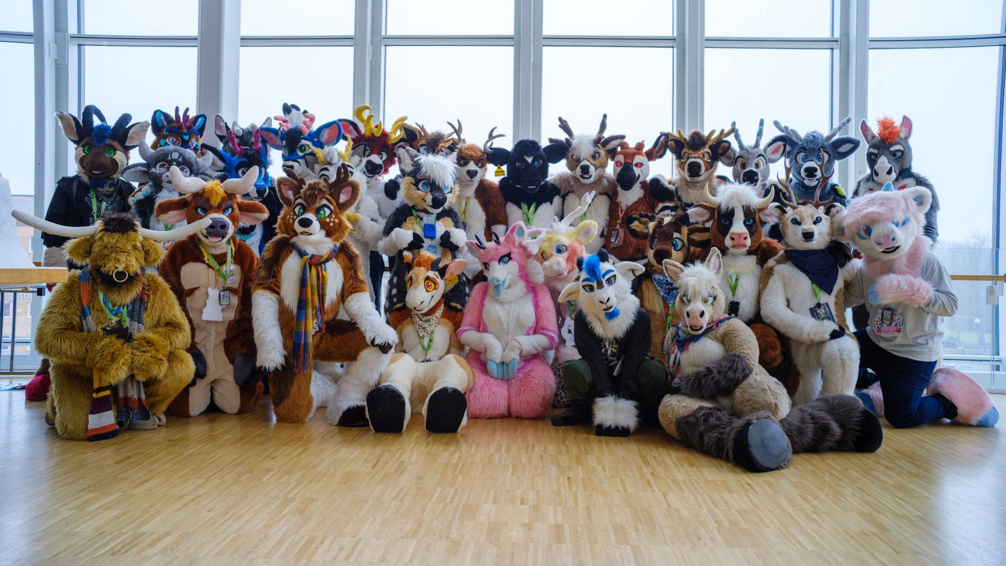 A colourful group of various hooved beings in fursuits, posing for the camera.