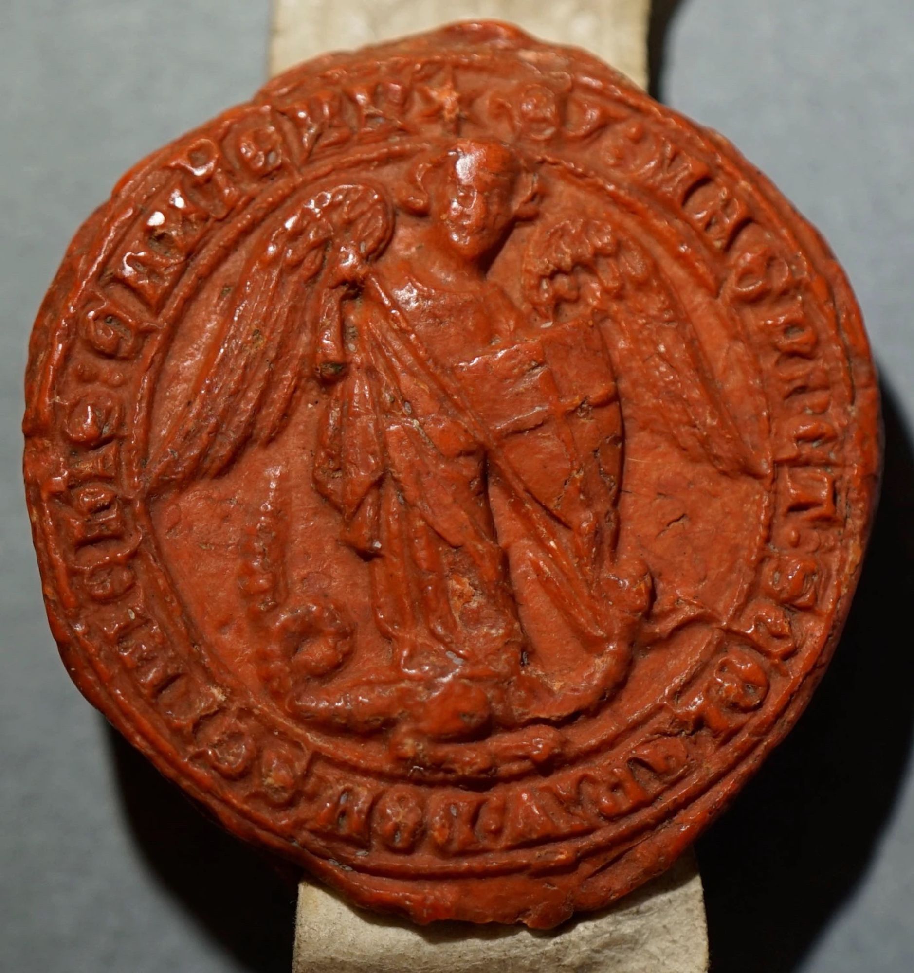 Original Seal from the Statutes of Michaelhouse depicting St Michael in typical style, with a sword and a serpent, c.1324.