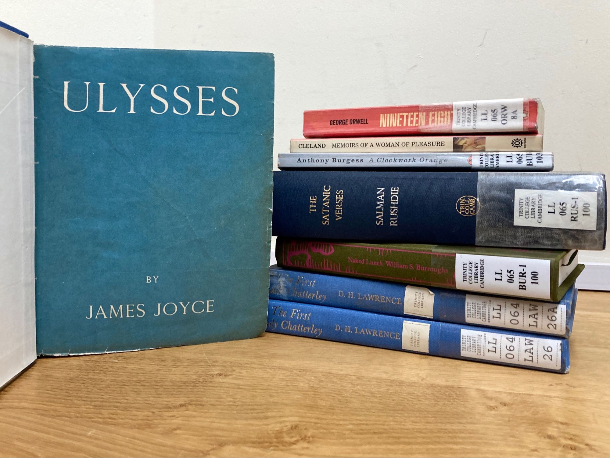 1928 edition of Ulysses by James Joyce, pictured alongside other formerly banned books, including Nineteen Eighty-Four, The Memoirs of a Woman of Pleasure, A Clockwork Orange, The Satanic Verses, Naked Lunch, and Lady Chatterley’s Lover.