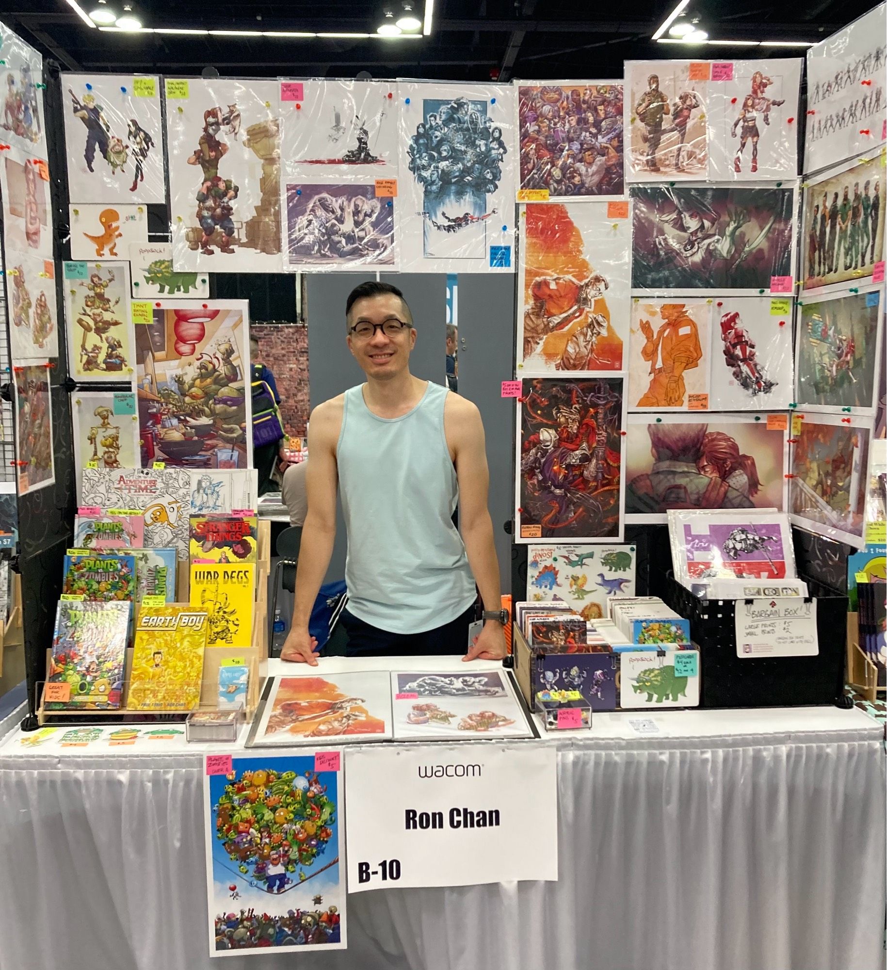 Photo of me behind my table of books and prints.