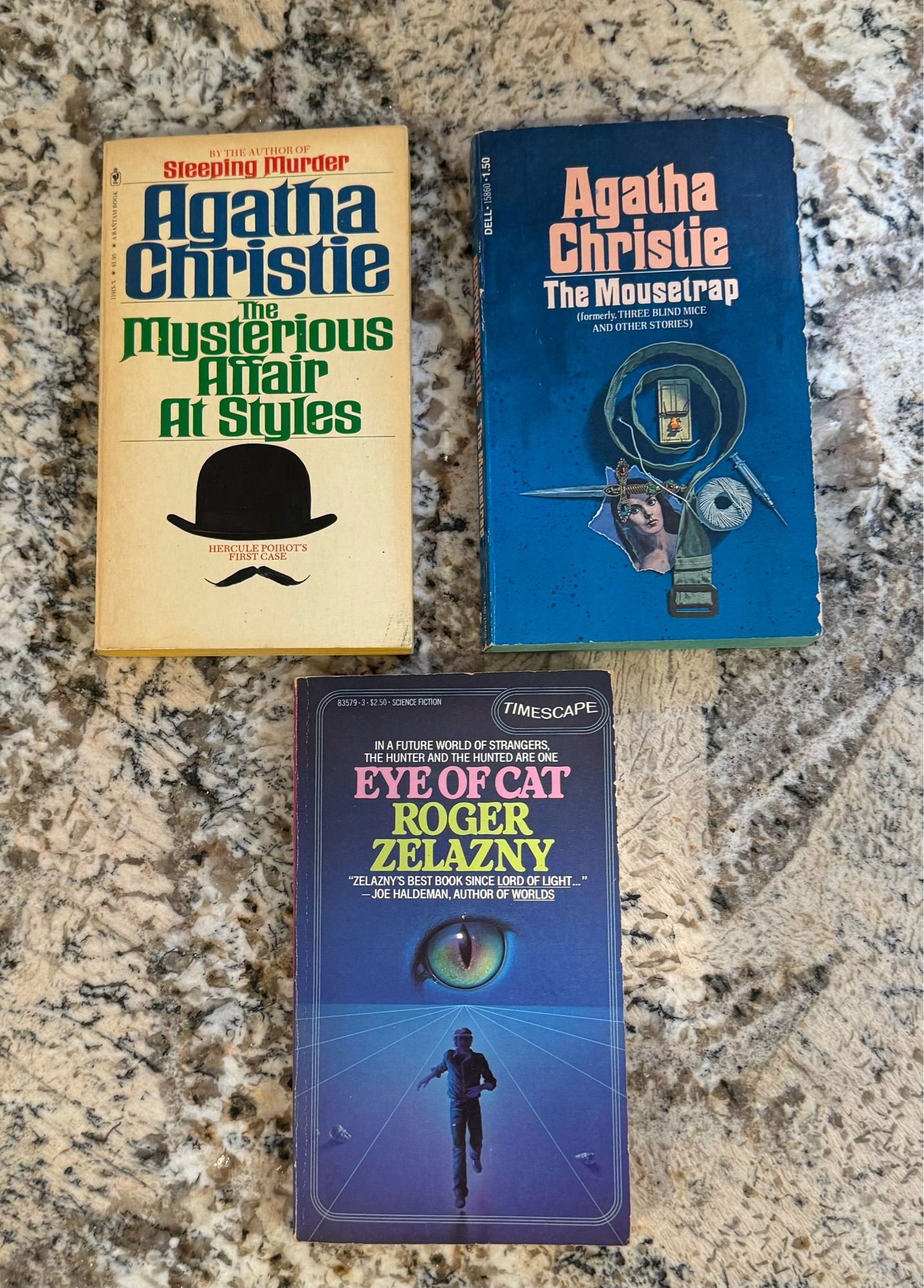 Two vintage Agatha Christie paperback novels, the mysterious affair at styles and the mousetrap, and a first timescape paperback edition of Roger zelazney’s eye of cat