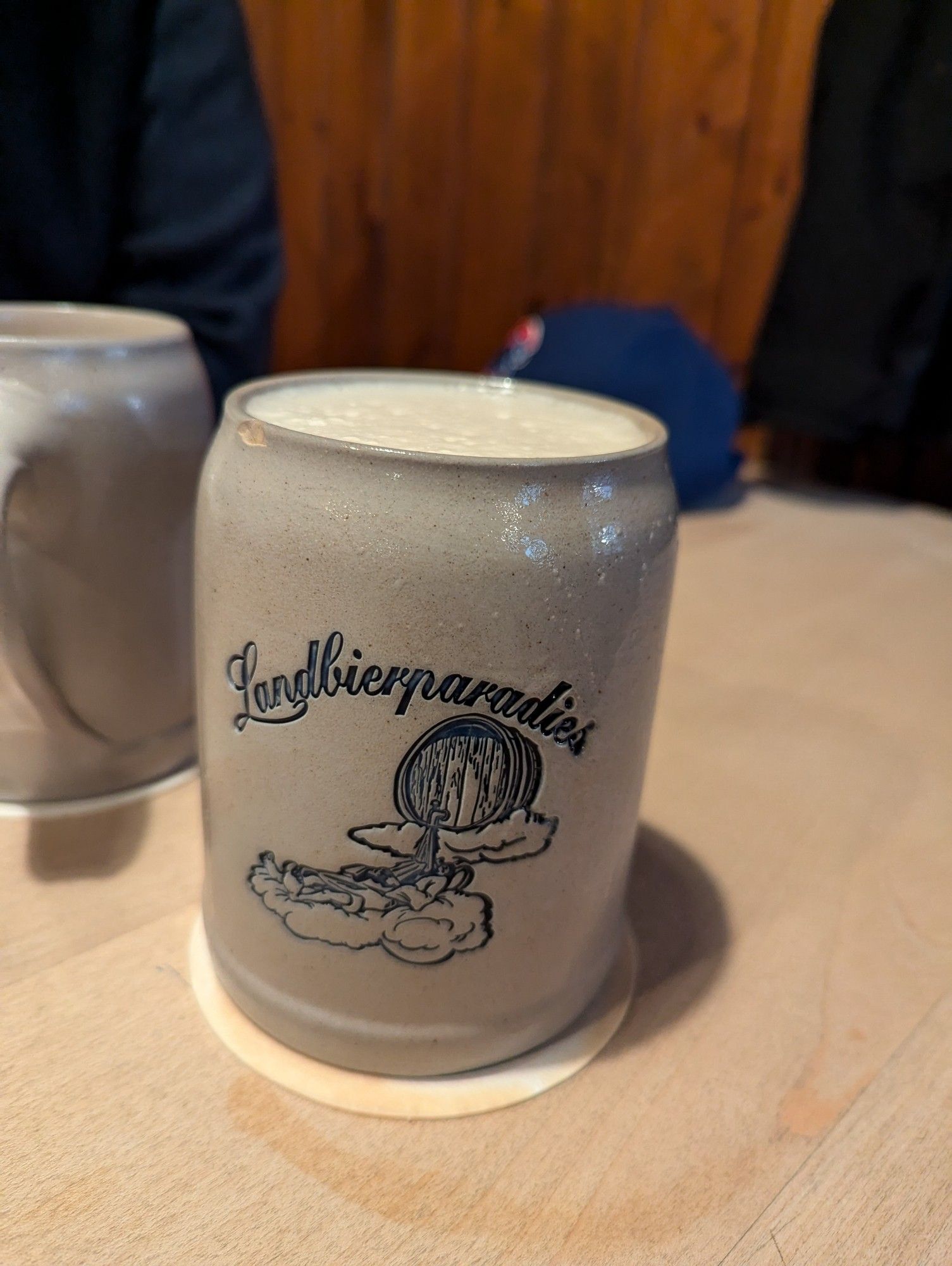 A half litre of Hummel Kellerbier in a Landbierparadies branded salt glazed Steinkrug.