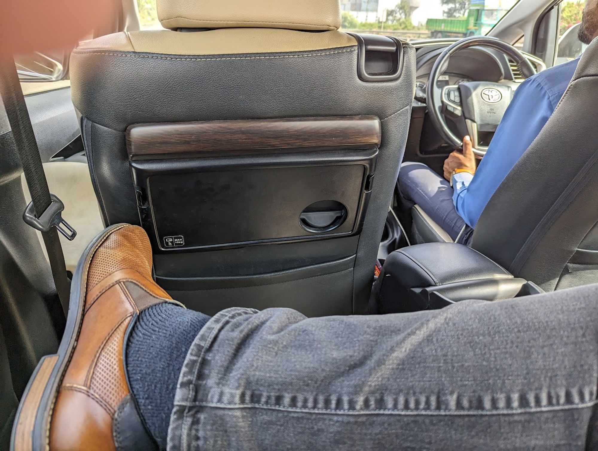 Me, showing plenty of leg space in a taxi from Mumbai to Pune (Toyota Innova)