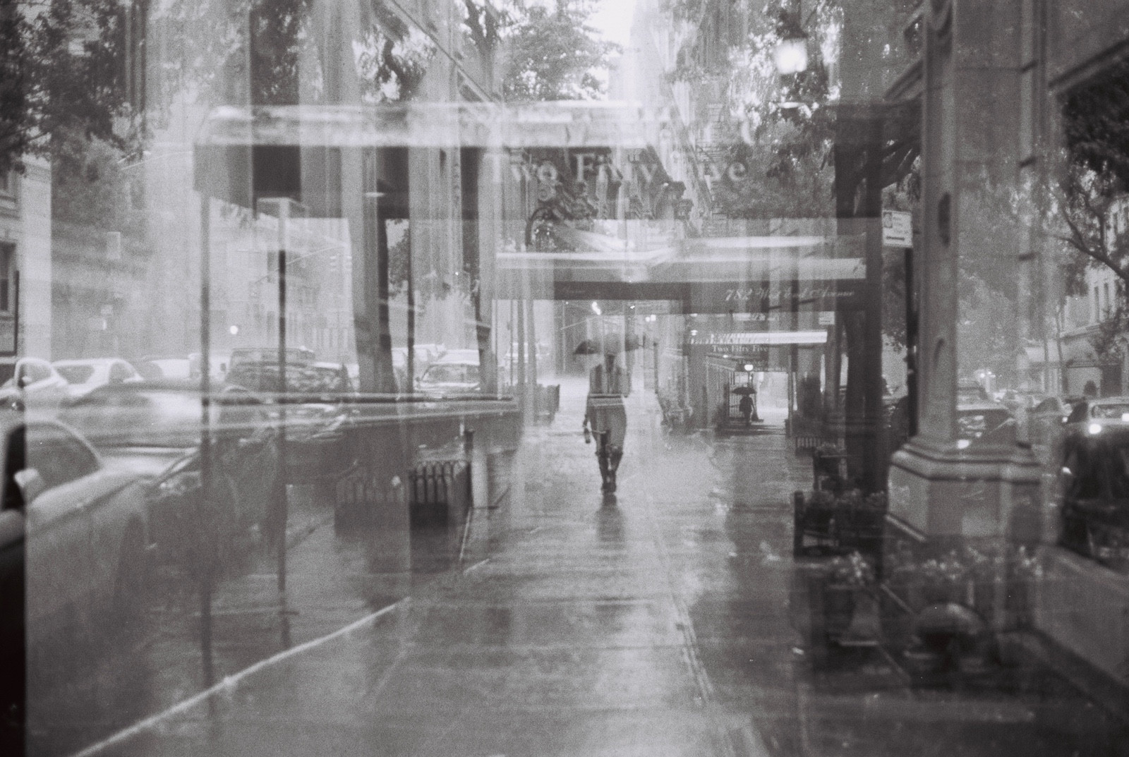 Double exposure of a woman walking in the rain.