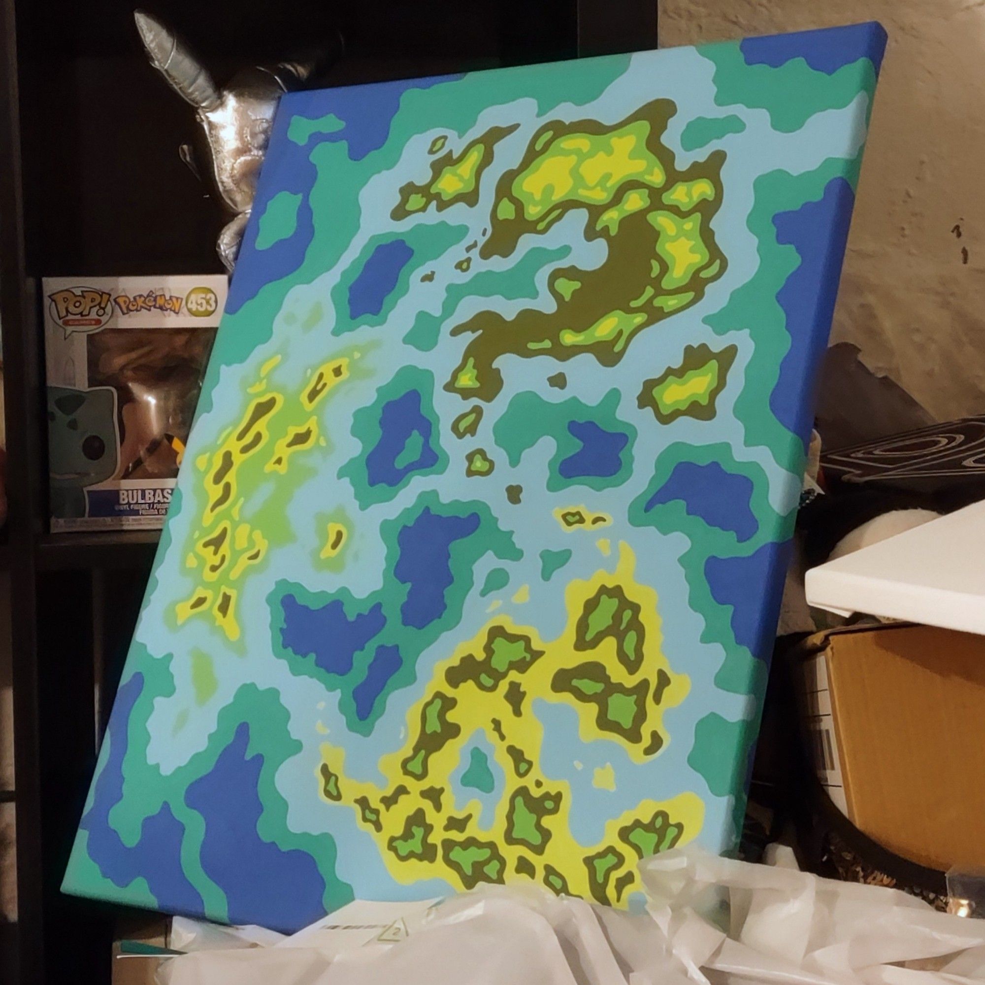 Abstract painting of organic green and blue shapes made to look like islands in the ocean