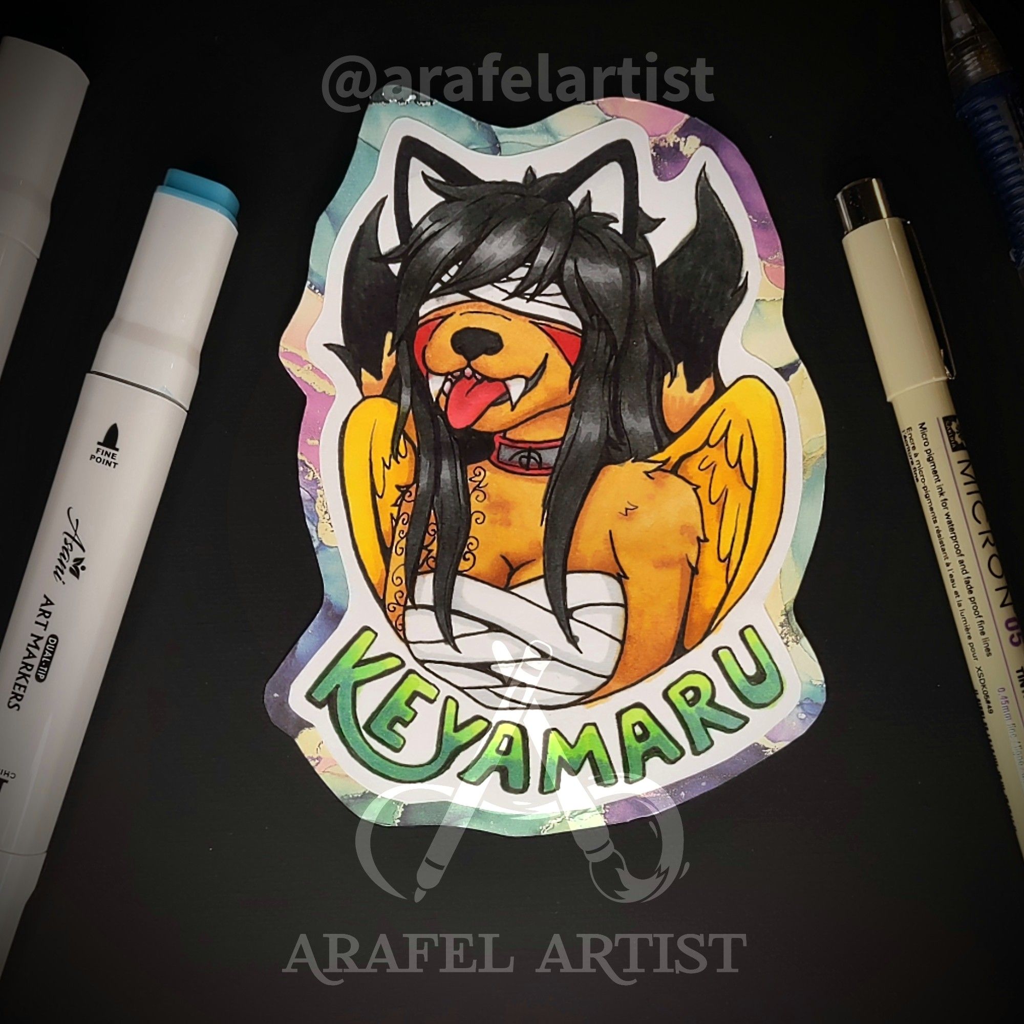 A drawing of a wolf fursona. This wolf has black ears, brown fur, red cheek marks, swirly tattoos on their right arm, golden wings, two tails, and black hair. Their eyes and torso are covered in bandages. Their tongue is sticking out of their mouth. The name Keyamaru is drawn below the character.