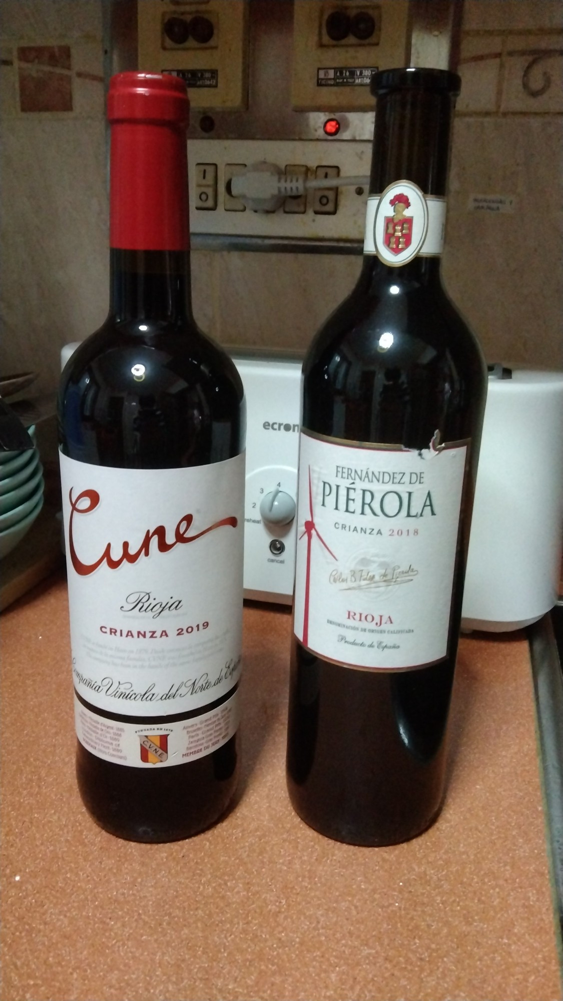 Dos botellas de vino tinto crianza, una al lado de la otra.