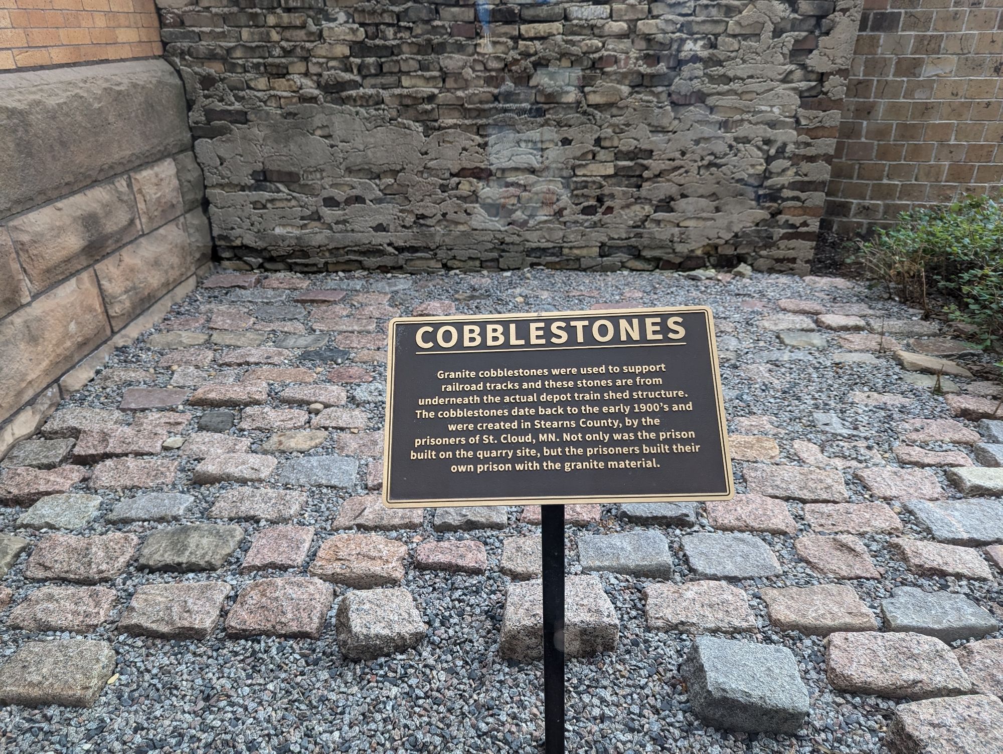 Roughly 10' x 10' space with granite cobblestones. A sign states that the cobblestones date back to the early 1900s.