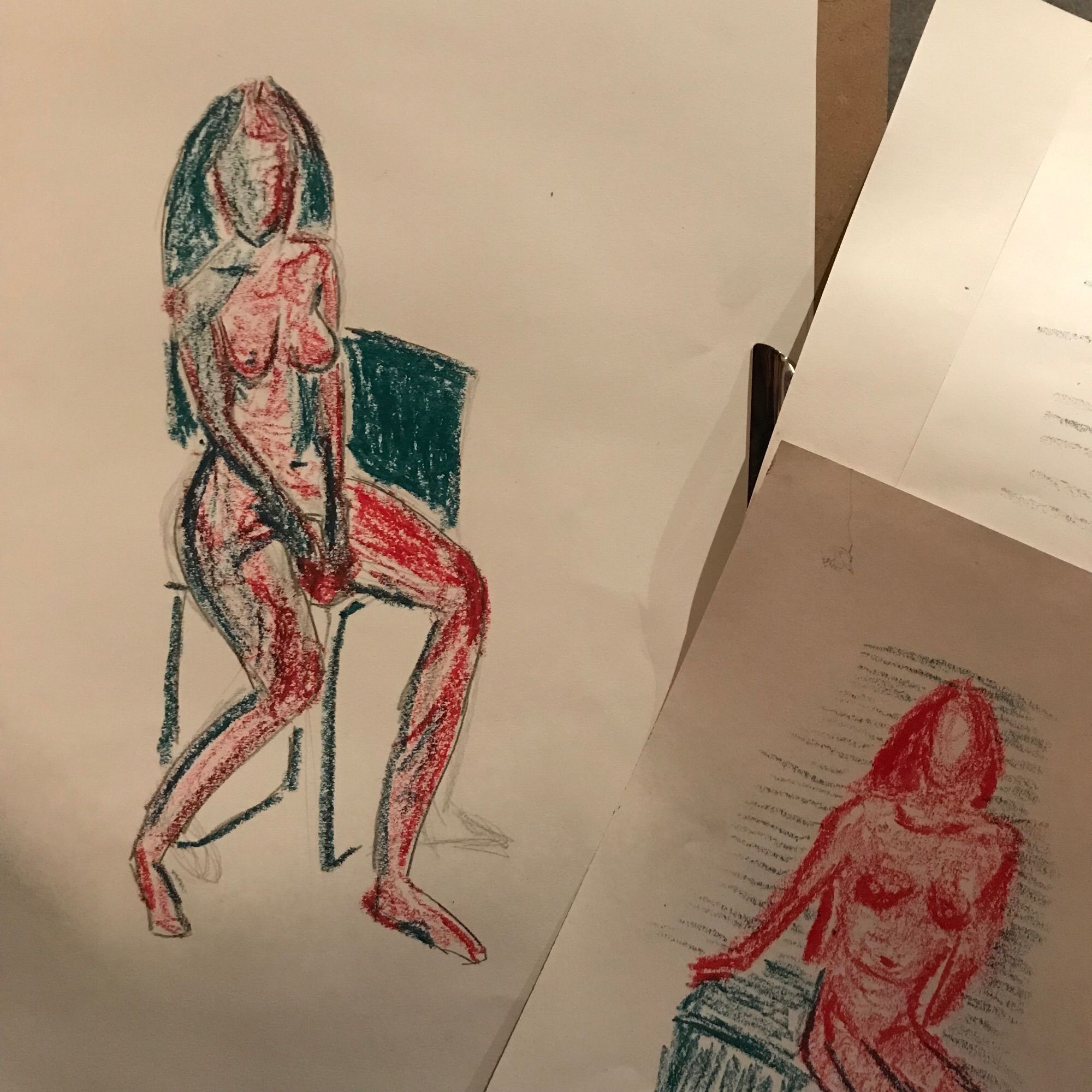 Life-drawing with red and green oil pastels, of a seated woman with long hair. No facial features shown.