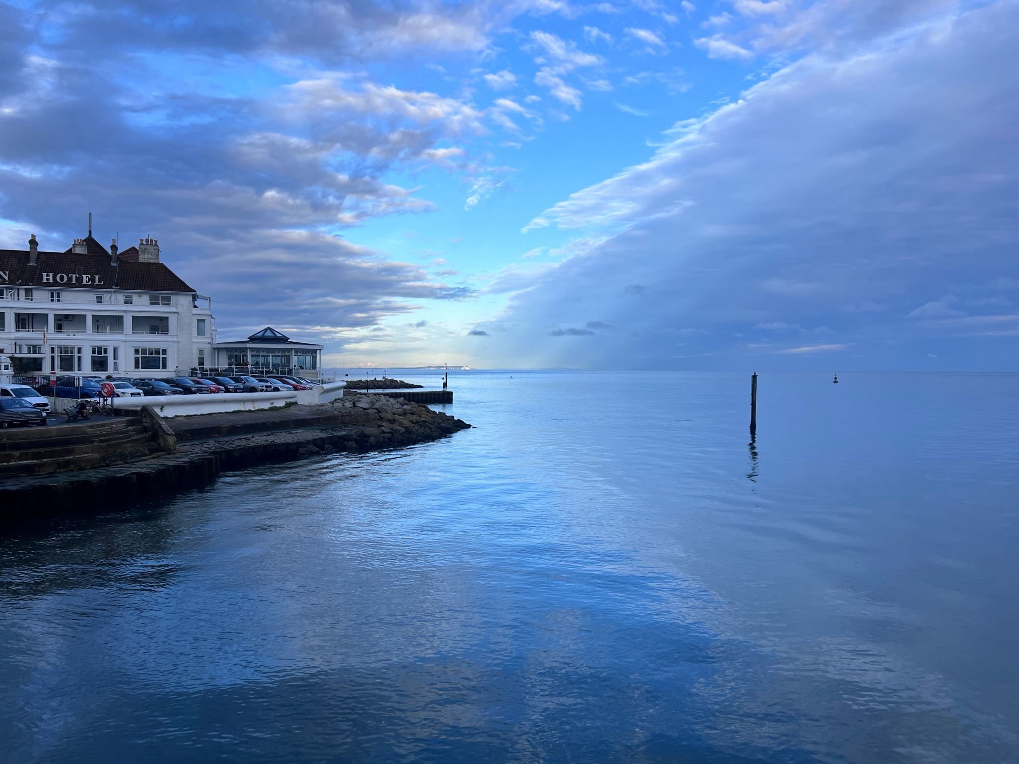 A calm sea water next to a hotel