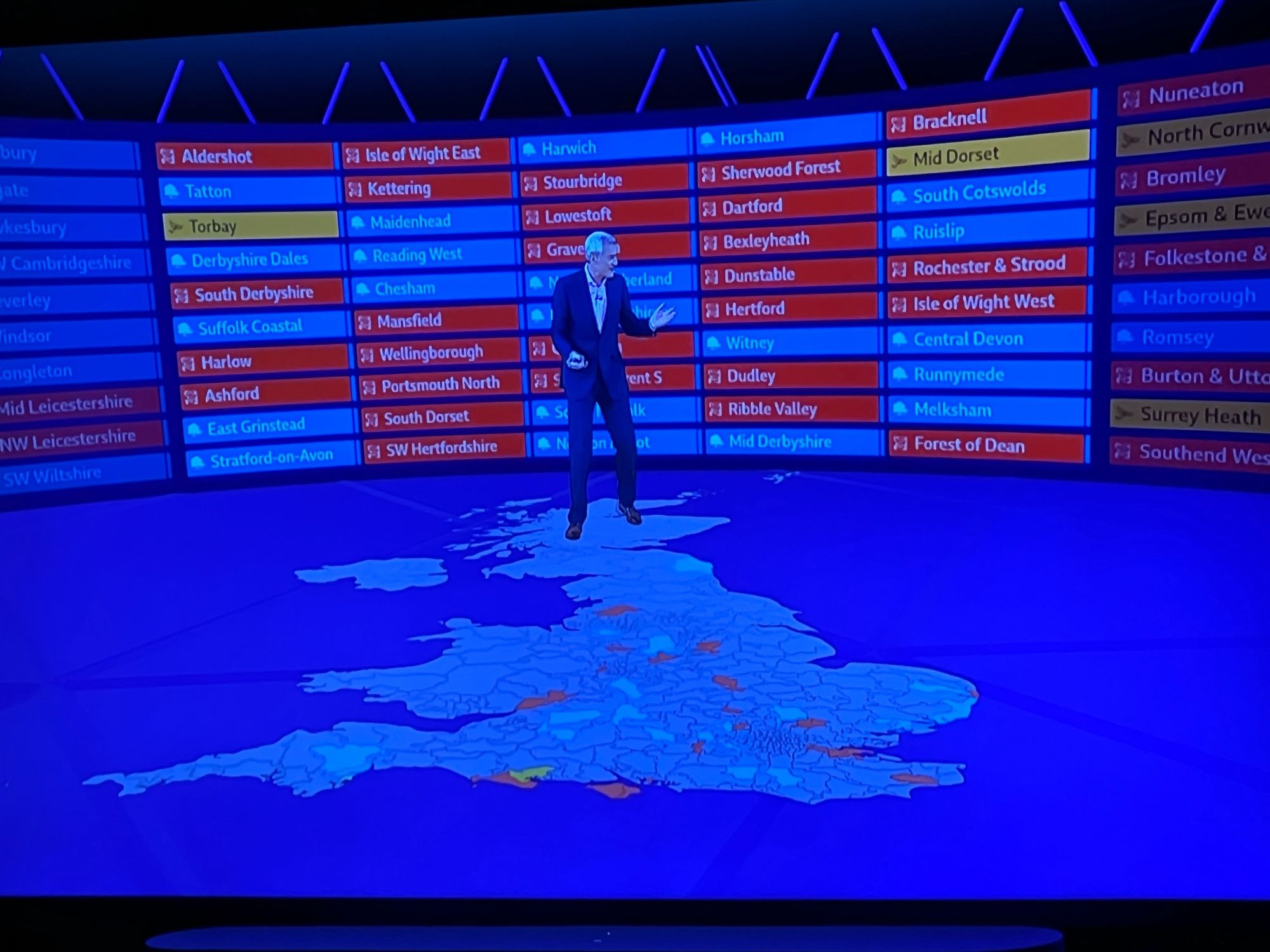 Jeremy Vine looking at exit poll forecasts for the UK election stood on a virtual map of the UK