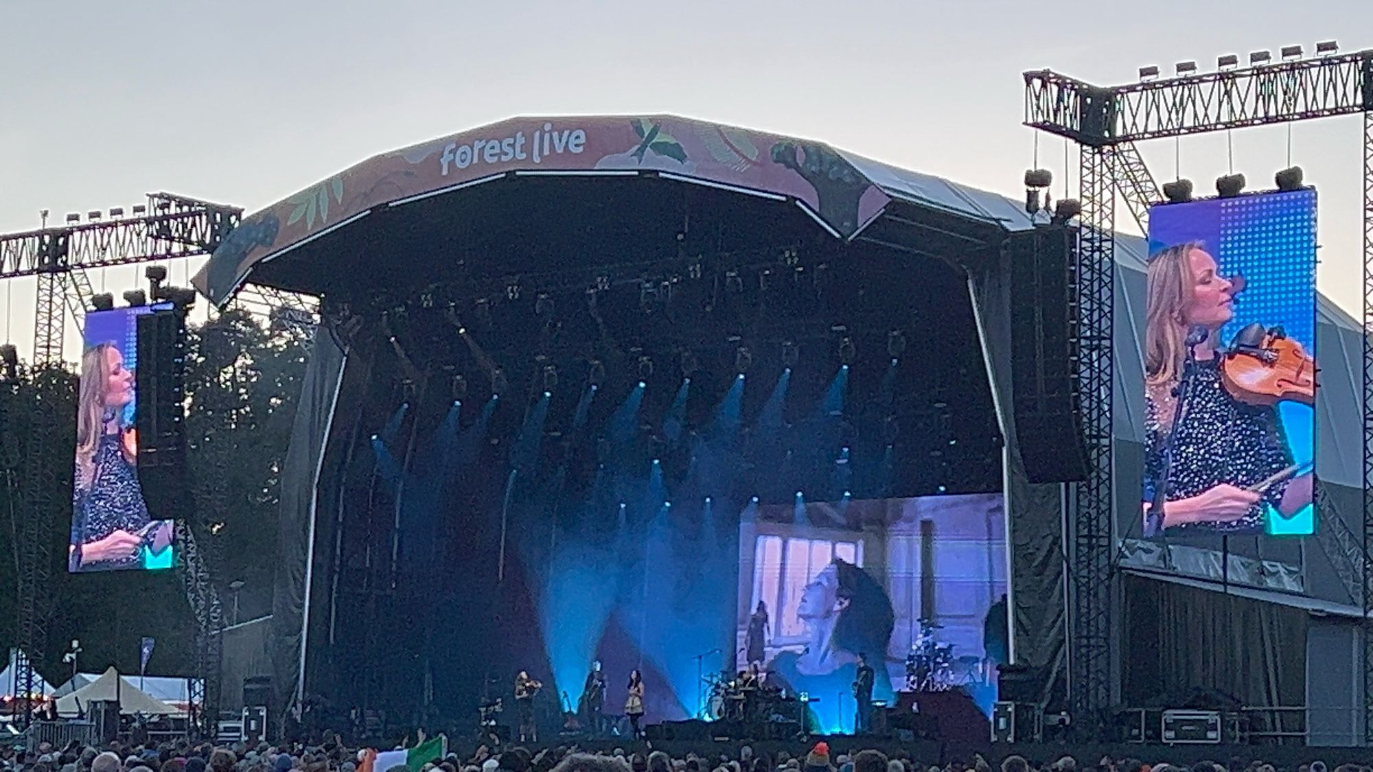 Large stage hosting the Corrs under an evening skyline