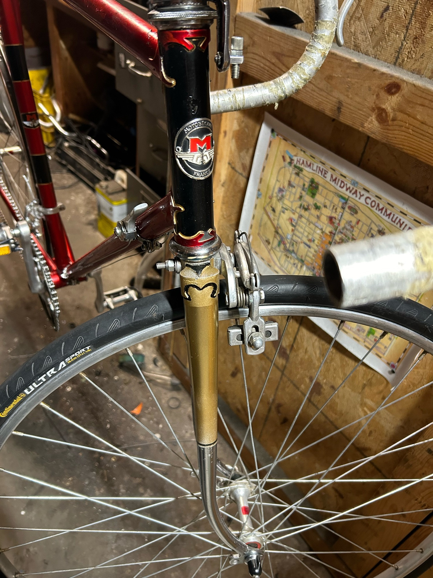 Repainted gold fork on a red bike