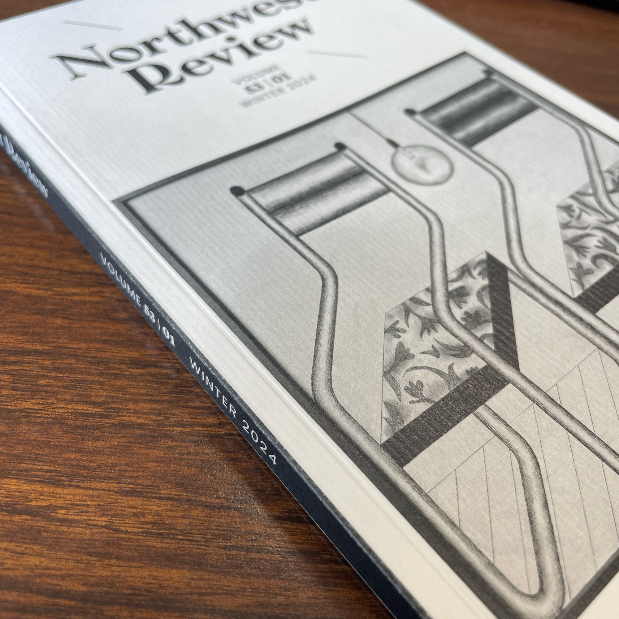 Close-up of part of cover and spine of Northwest Review, showing thick paper quality on cover and clear printing of graphics and grayscale artwork