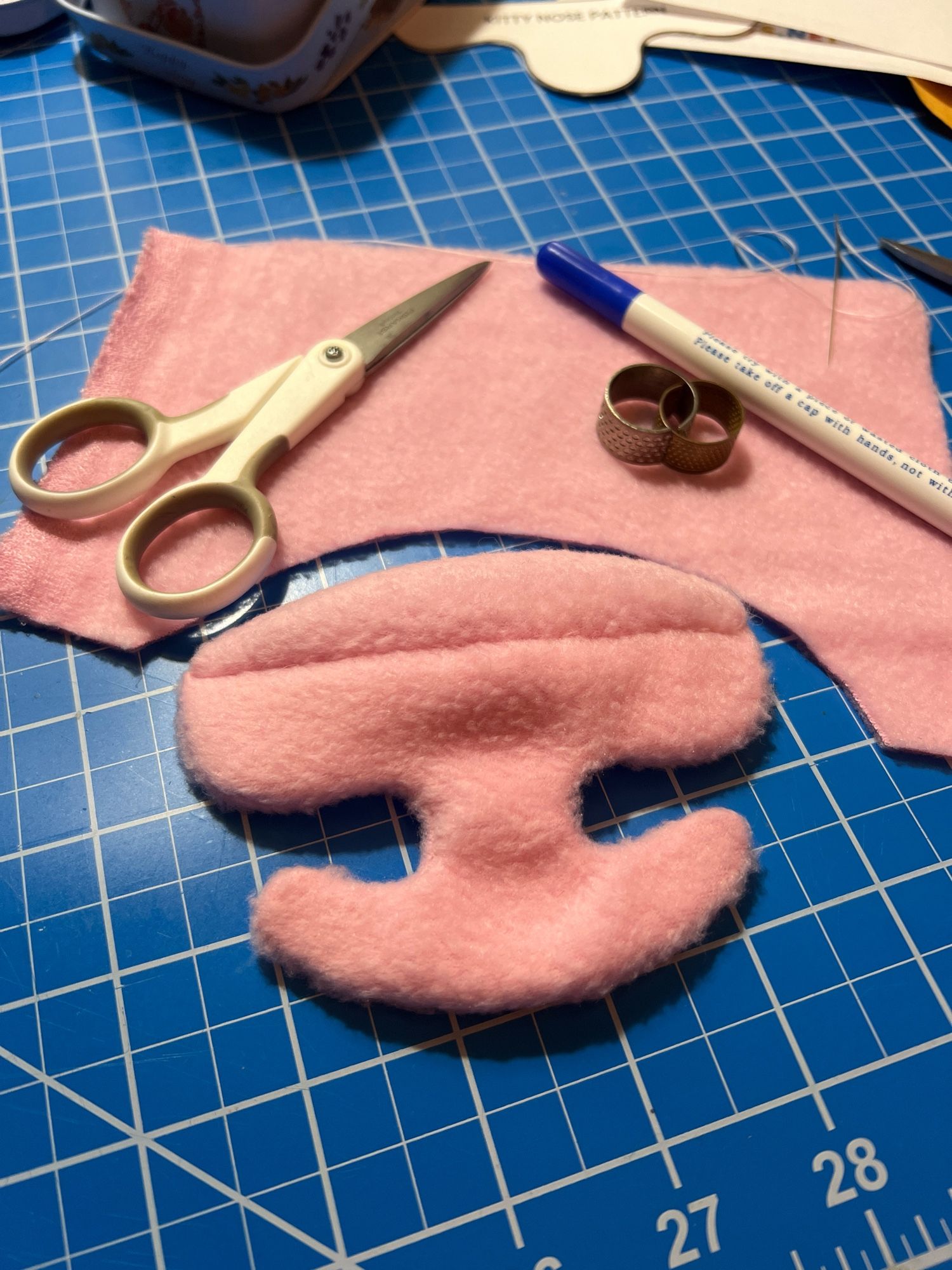 Pink fursuit nose completed and waiting for a head to be placed on.