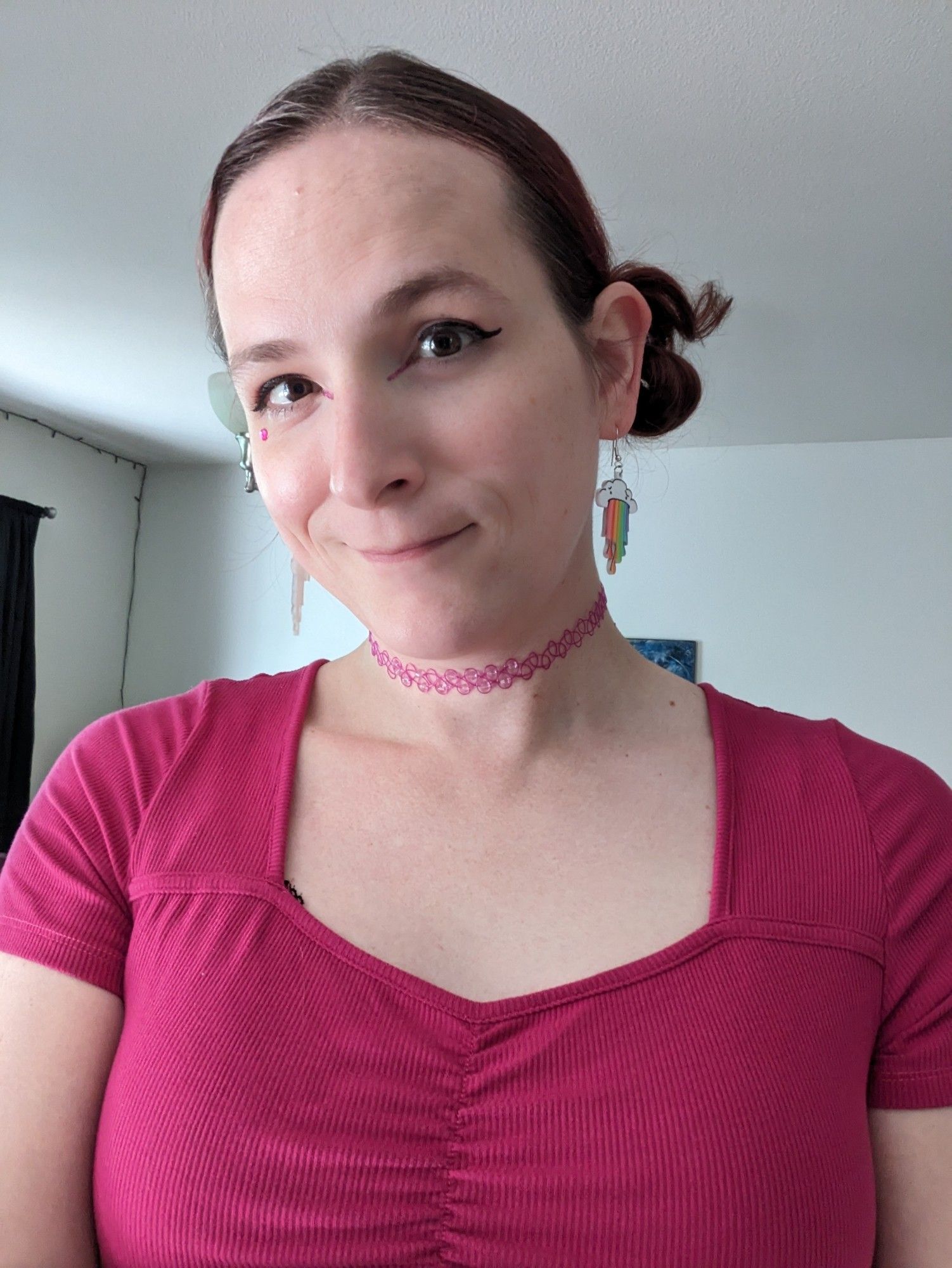 Selfie of Jacey in a pink top and choker with pink makeup accents