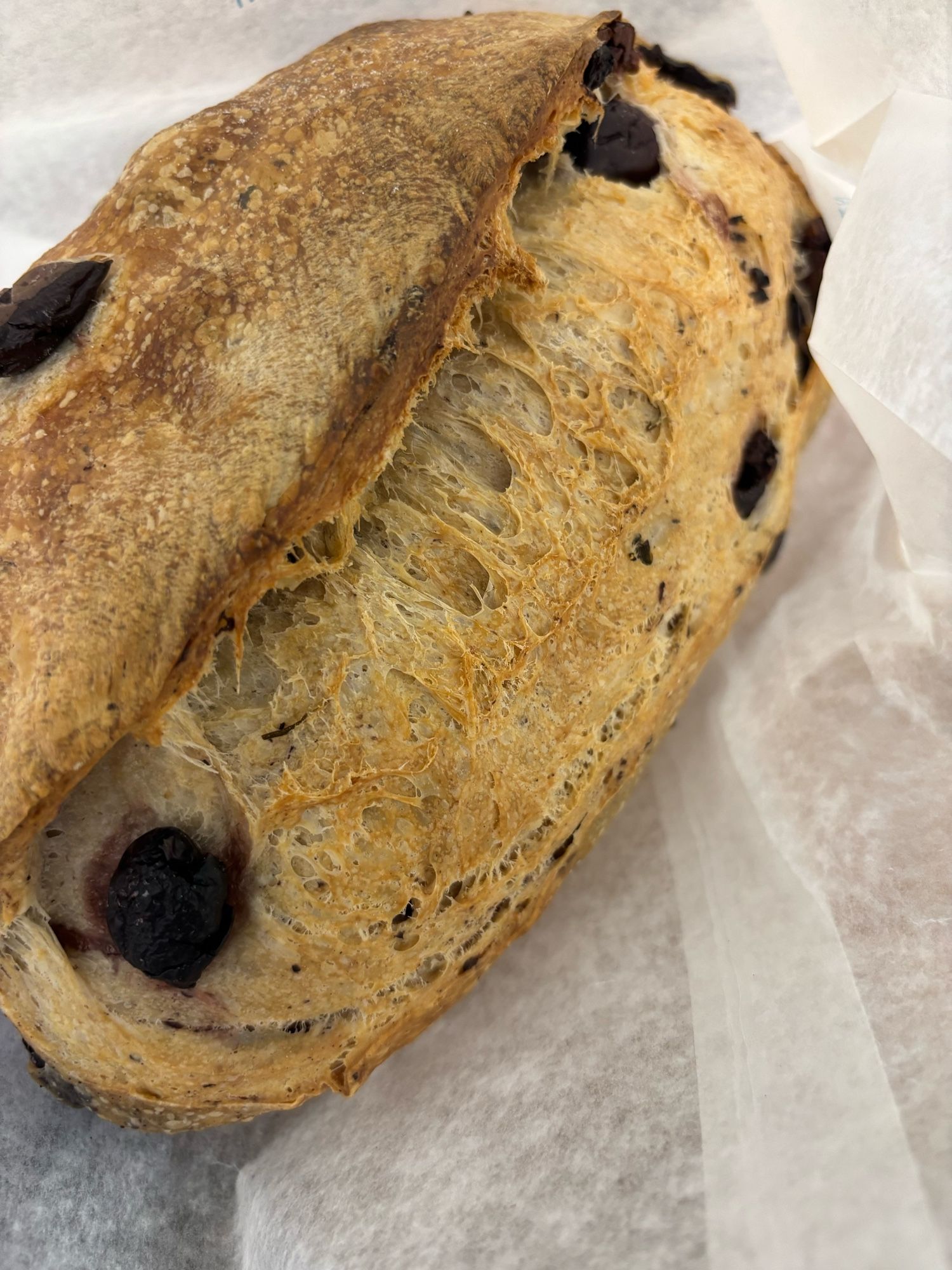 An absolutely perfect loaf of olive sourdough