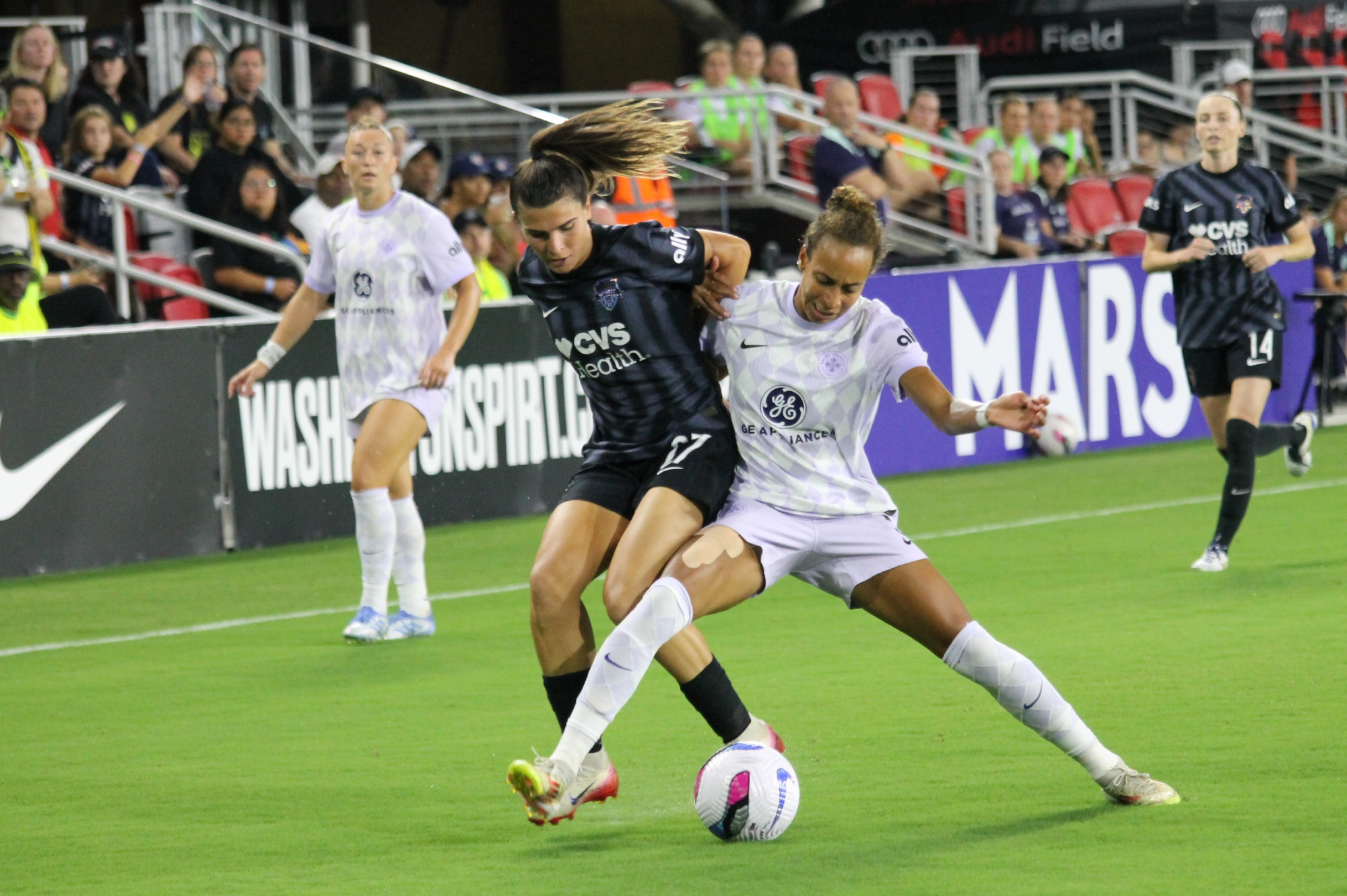 Sofia Cantore of Washington Spirit and Ellie Jean of Racing Louisville tangle up as they compete for the ball.