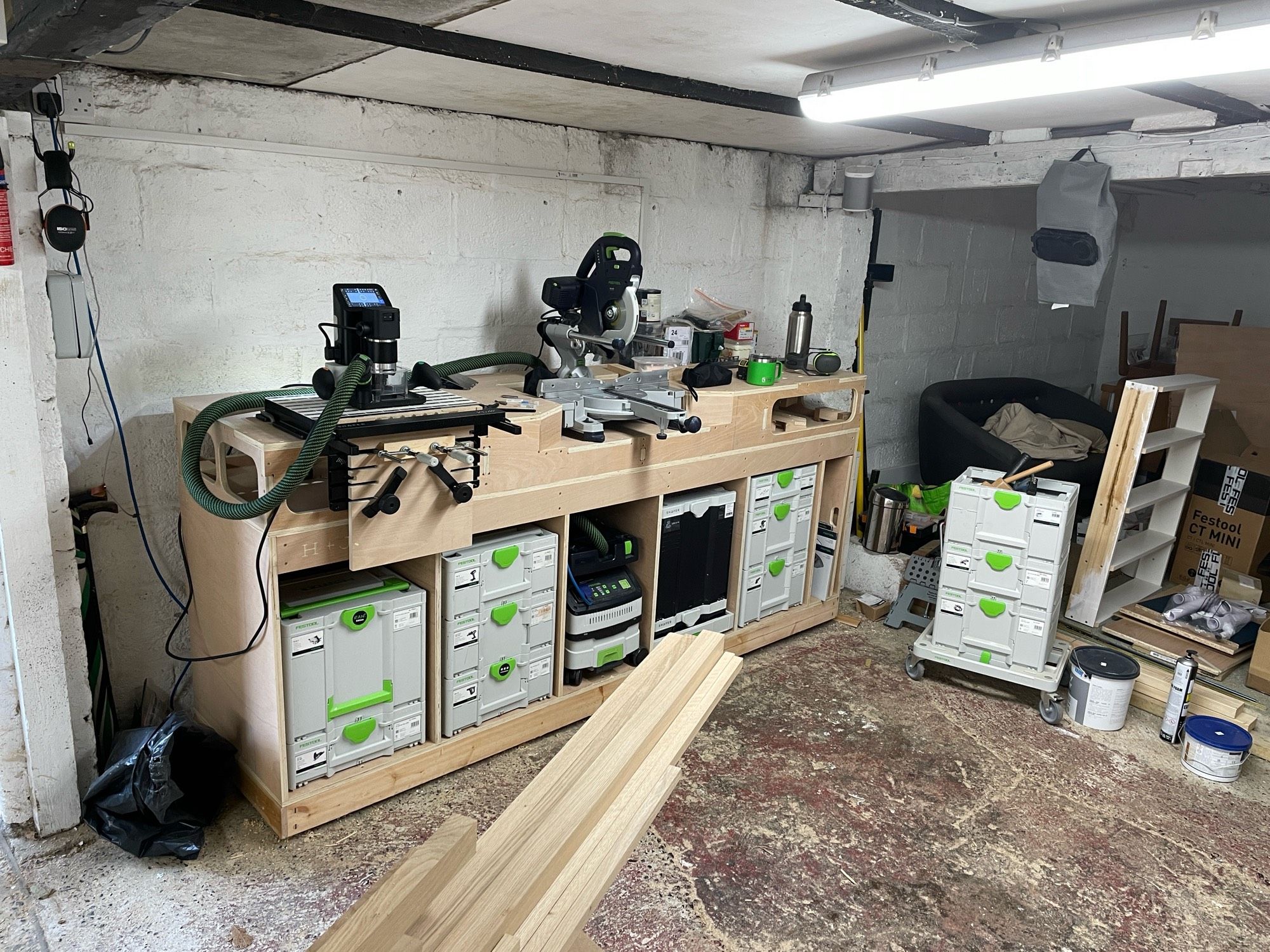 Plywood workbench with tools underneath.