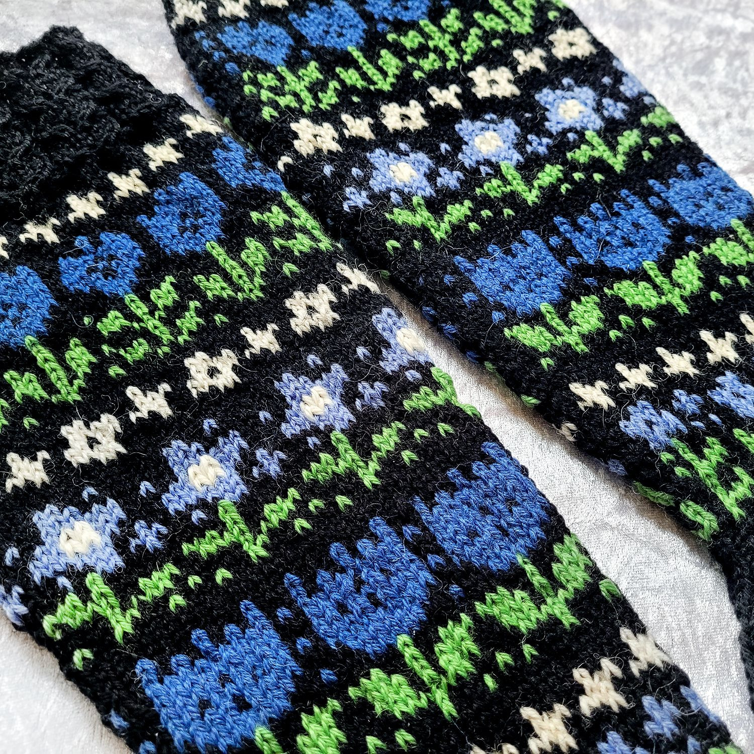 a detail shot of the knee-high socks, featuring three different types of flowers.