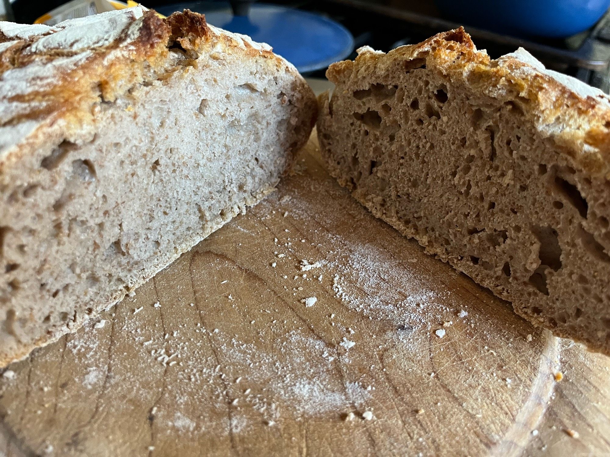 Sourdough bread cut in half on a wooden board