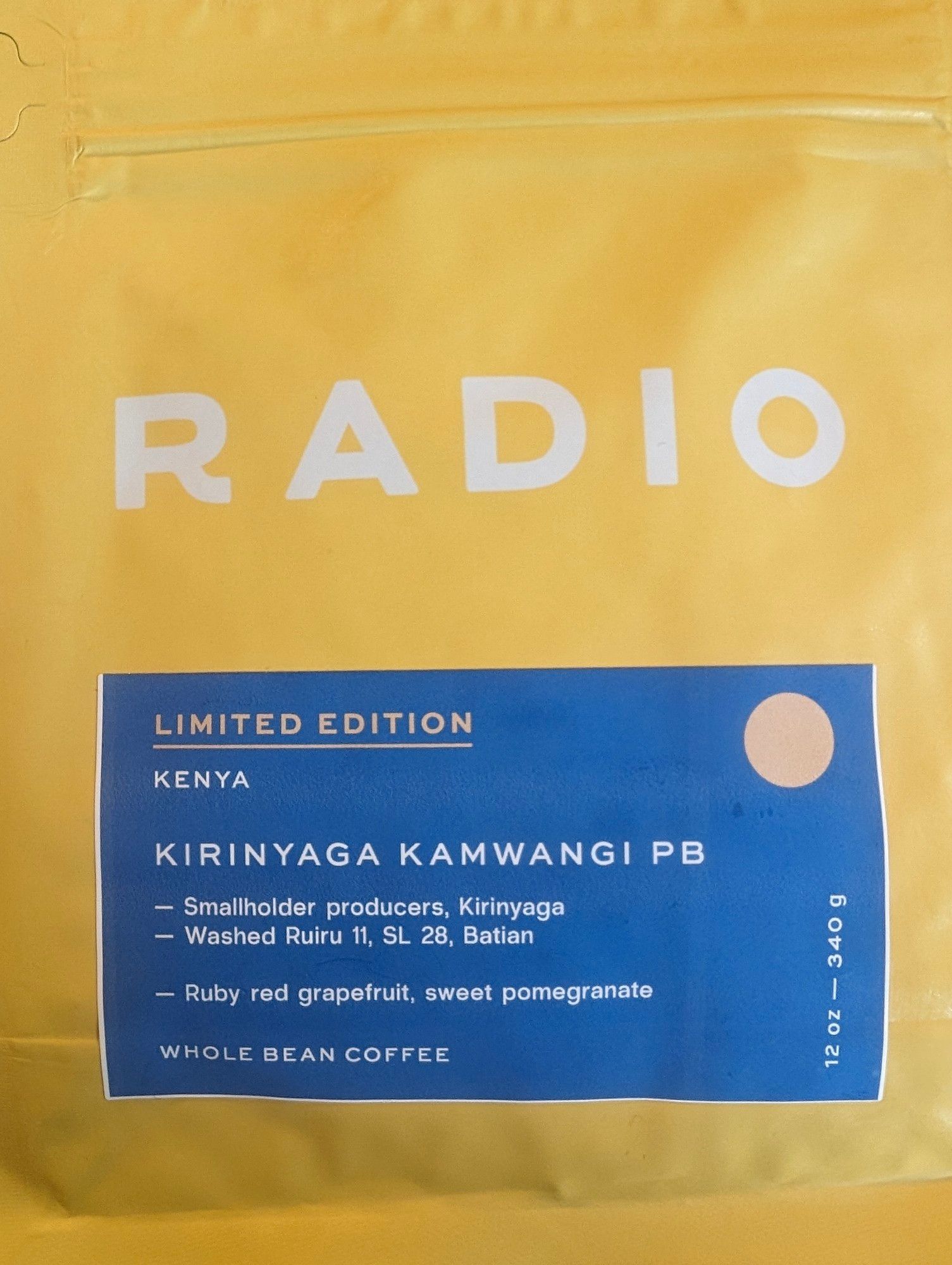 yellow bag of coffee with RADIO in white text and the following beneath on a blue label:
LIMITED EDITION
KENYA
KIRINYAGA KAMWANGI PB

-Smallholder producers, Kirinyaga 
-Washed Ruiru 11, SL 28, Batian
-Ruby red grapefruit, sweet pomegranate
WHOLE BEAN COFFEE