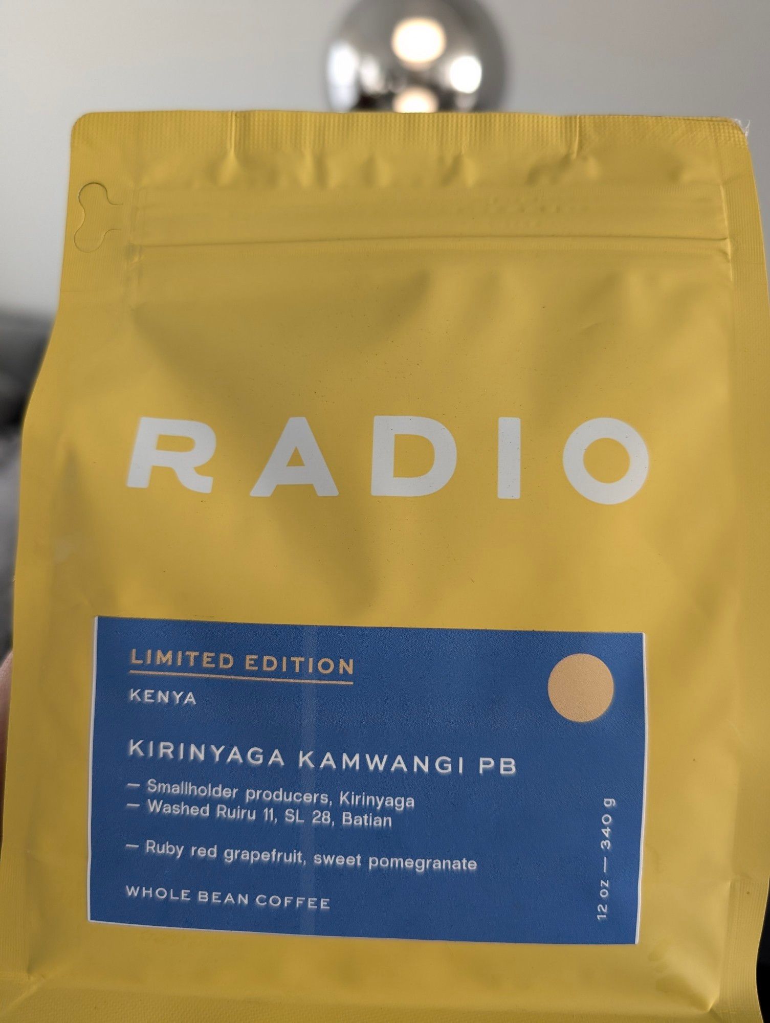 yellow bag of coffee with text RADIO with a blue label with text as follows:

LIMITED EDITION
KENYA

KIRINYAGA KAMWANGI PB
-Smallholder producers, Kirinyaga 
-Washed Ruiru 11, SL 28, Batian

-Ruby red grapefruit, sweet pomegranate

WHOLE BEAN COFFEE