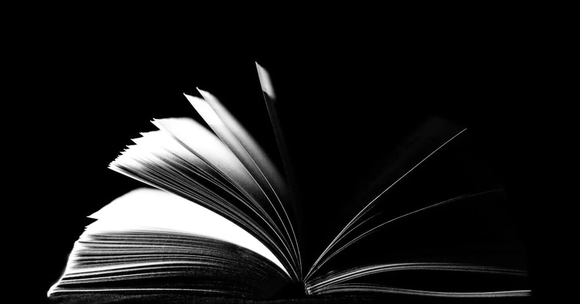 Actions and Resources for Banned Book Week and Beyond. Read more at mombian.com. Image: Open book in black and white.