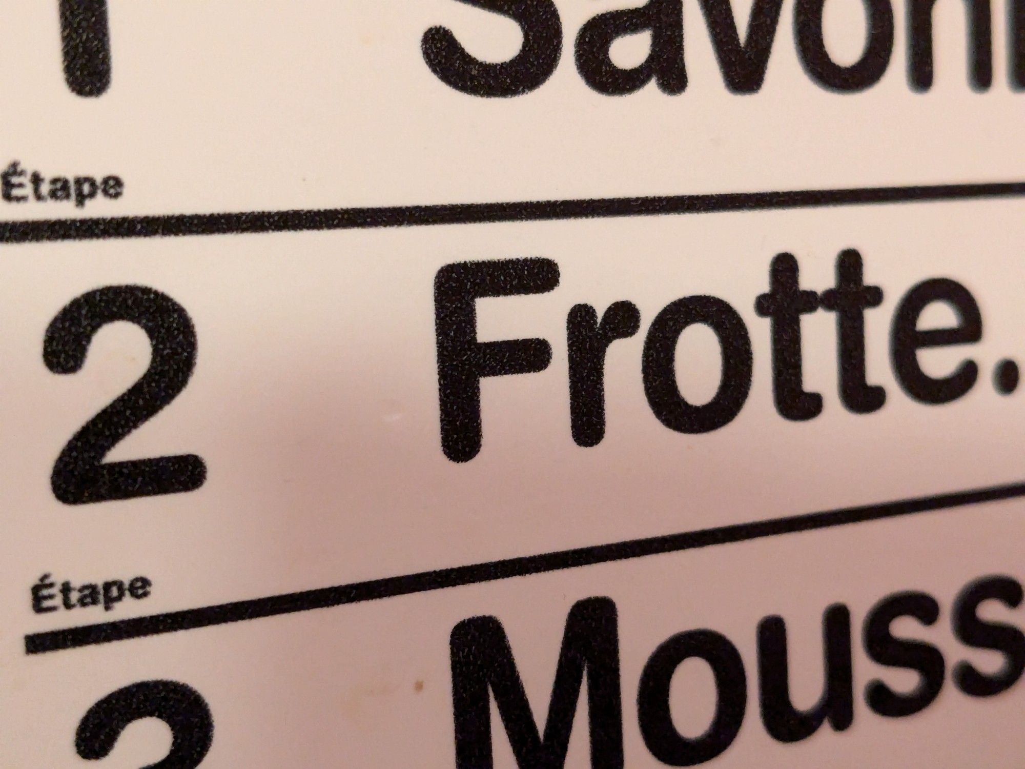 close up of a sign that says 2 étape frotte