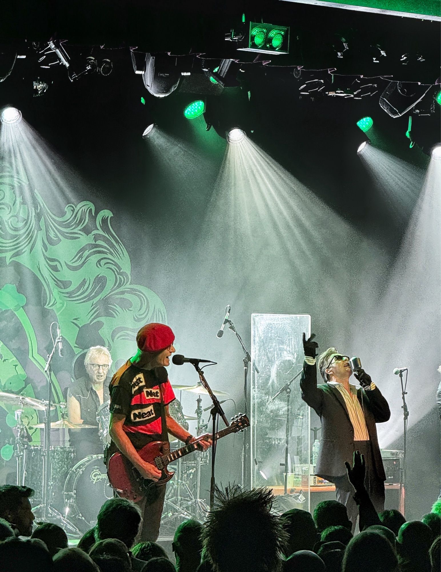 Members of the Damned on stage under bright lights