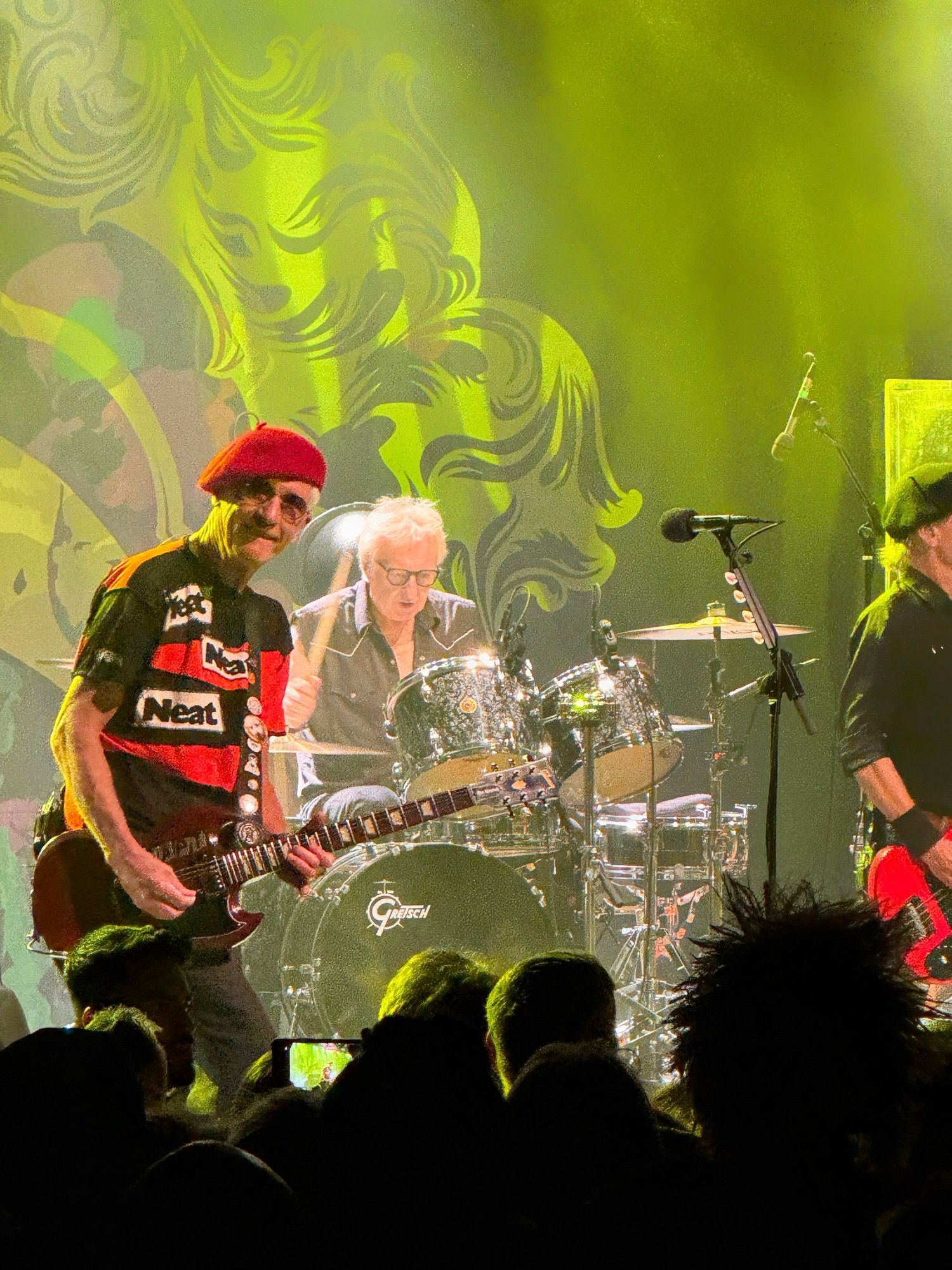 Members of the Damned on stage under bright lights