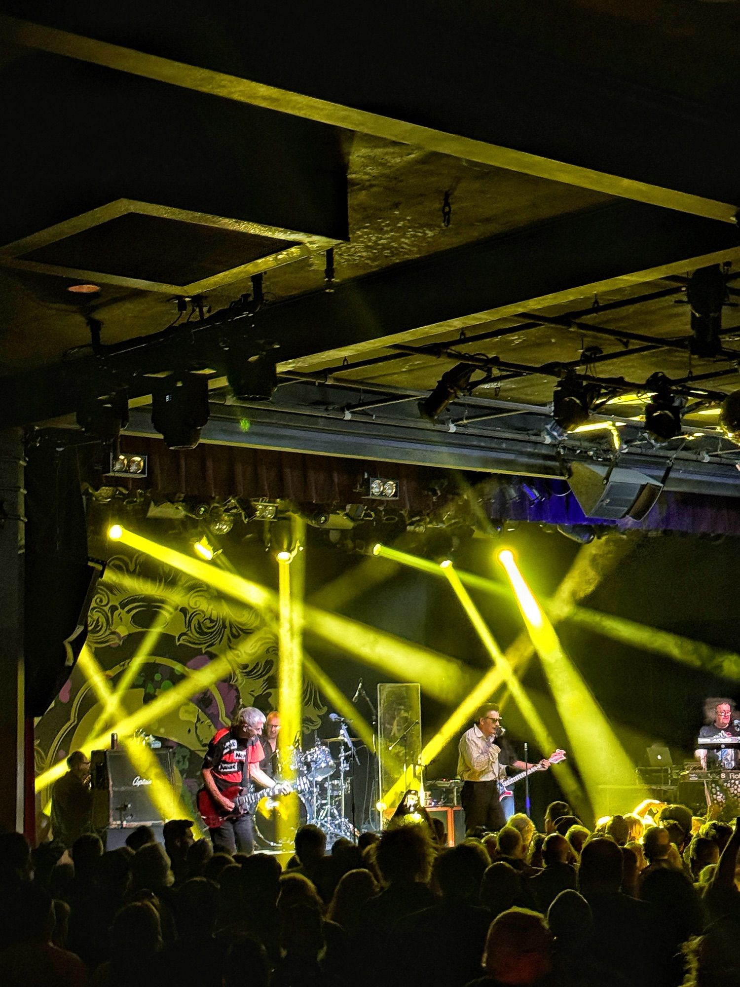 Members of the Damned on stage under bright lights