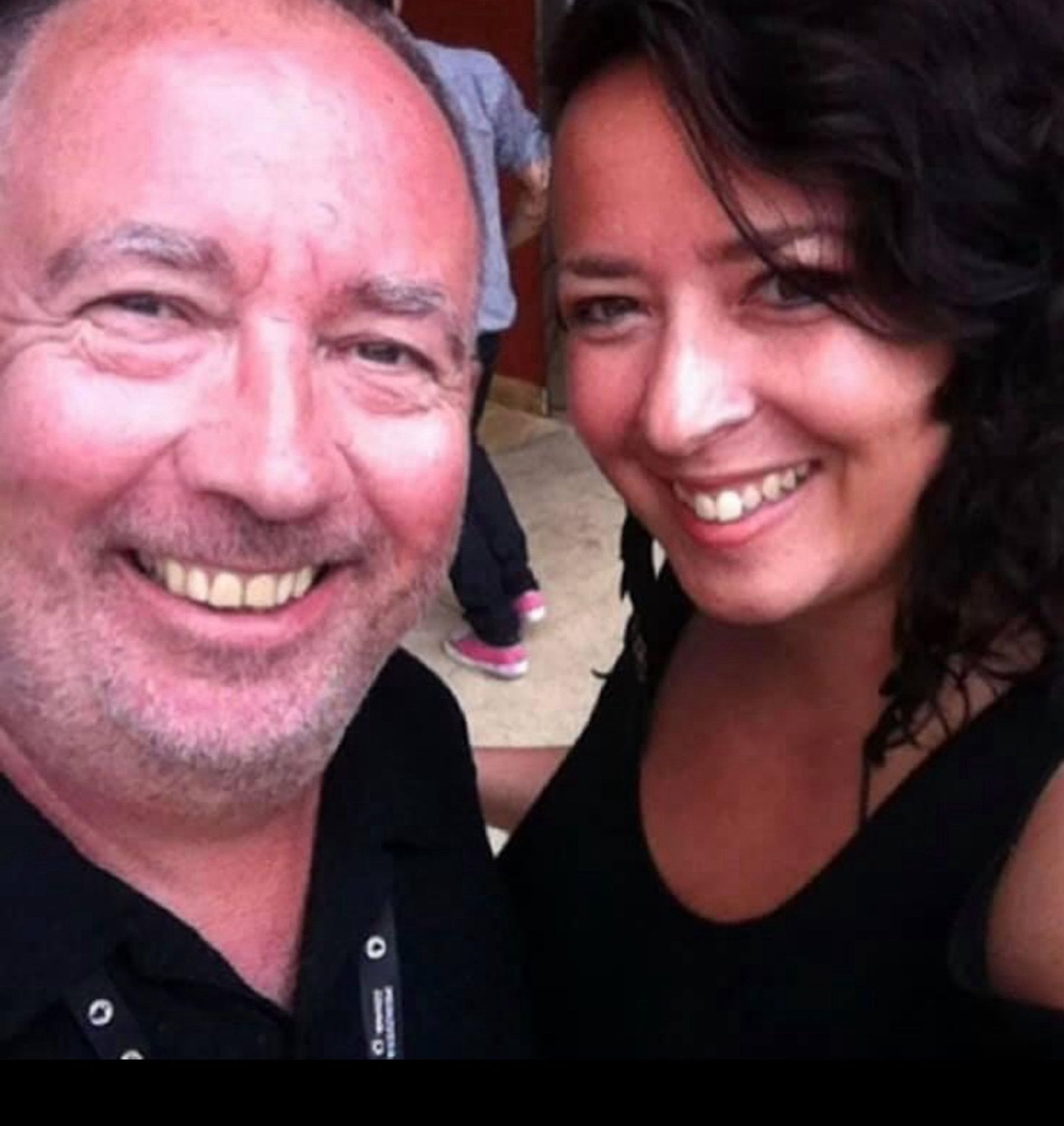 Photo of middle-aged Caucasian man on left and brunette woman on right, both are smiling