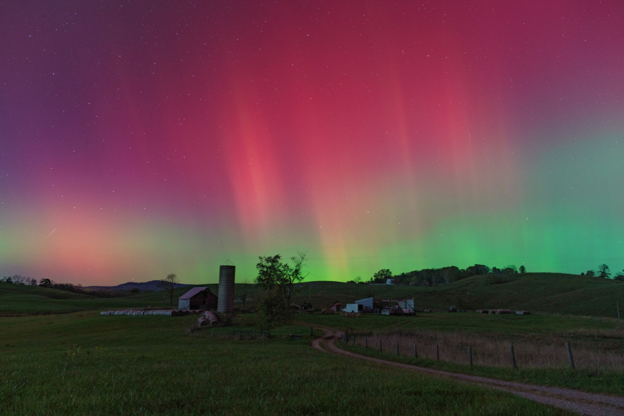 A gravel country lane gently winds through this colorful rural night skyscape. Captured from Monroe County in southern West Virginia on the evening of October 10, the starry sky above is a familiar sight. Shimmering curtains of aurora borealis or northern lights definitely do not make regular appearances here, though. Surprisingly vivid auroral displays were present on that night at very low latitudes around the globe, far from their usual northern and southern high latitude realms. The extensive auroral activity was evidence of a severe geomagnetic storm triggered by the impact of a coronal mass ejection (CME), an immense magnetized cloud of energetic plasma. The CME was launched toward Earth from the active Sun following a powerful X-class solar flare.   Growing Gallery: Global aurora during October 10/11, 2024