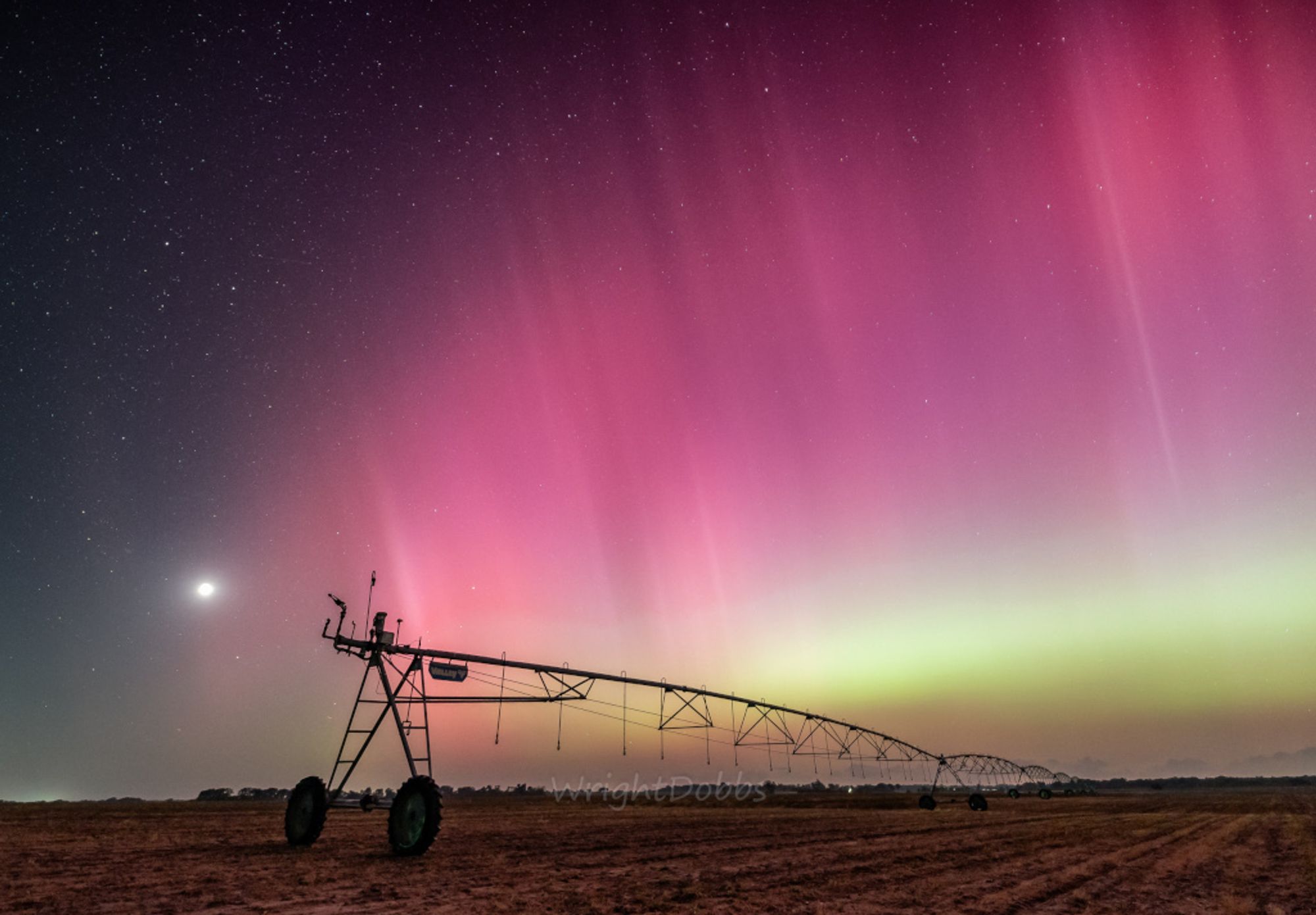 A familiar sight from Georgia, USA, the Moon sets near the western horizon in this rural night skyscape. Captured on May 10 before local midnight, the image overexposes the Moon's bright waning crescent at left in the frame. A long irrigation rig stretches across farmland about 15 miles north of the city of Bainbridge. Shimmering curtains of aurora shine across the starry sky though, definitely an unfamiliar sight for southern Georgia nights. Last weekend, extreme geomagnetic storms triggered by the recent intense activity from solar active region AR 3664 brought epic displays of aurora, usually seen closer to the poles, to southern Georgia and even lower latitudes on planet Earth. As solar activity ramps up, more storms are possible.   AuroraSaurus: Report your aurora observations