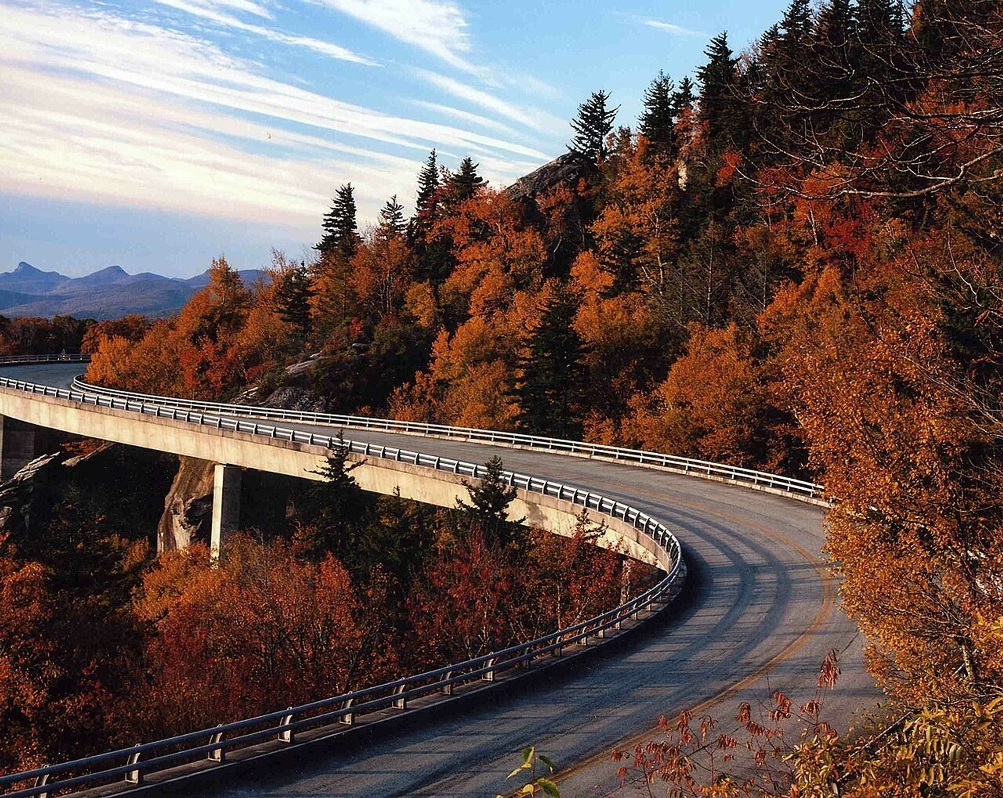 The link cove viaduct surrounded by fall foliage. A bridge built into the side of a mountain.