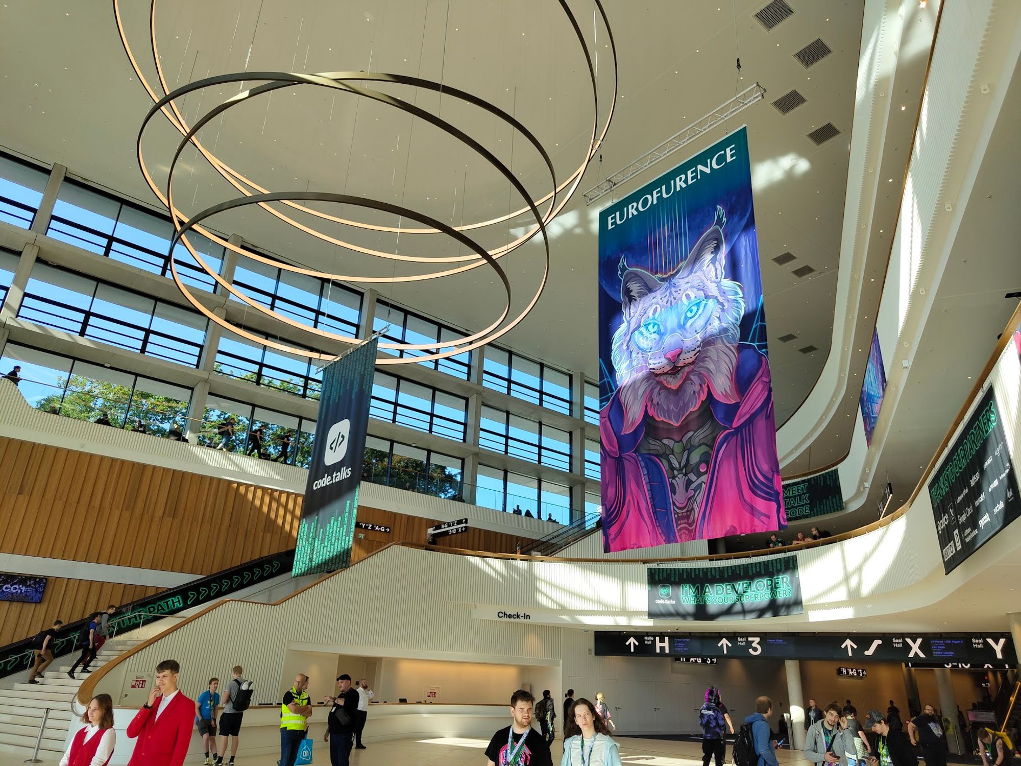 The main hall of the CCH with a code.talks banner on the left and a Eurofurence banner on the right.