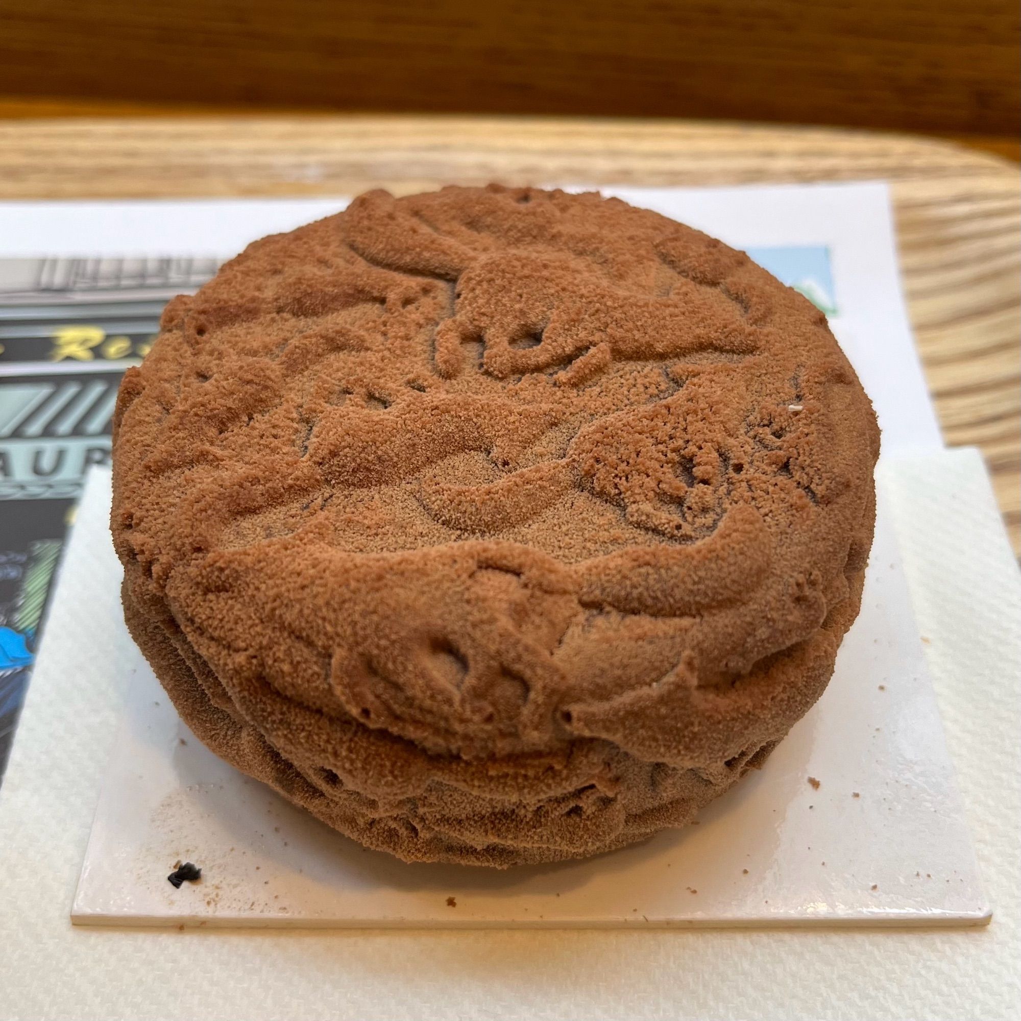 A small round chocolate cake covered in moulded chocolate fox motifs