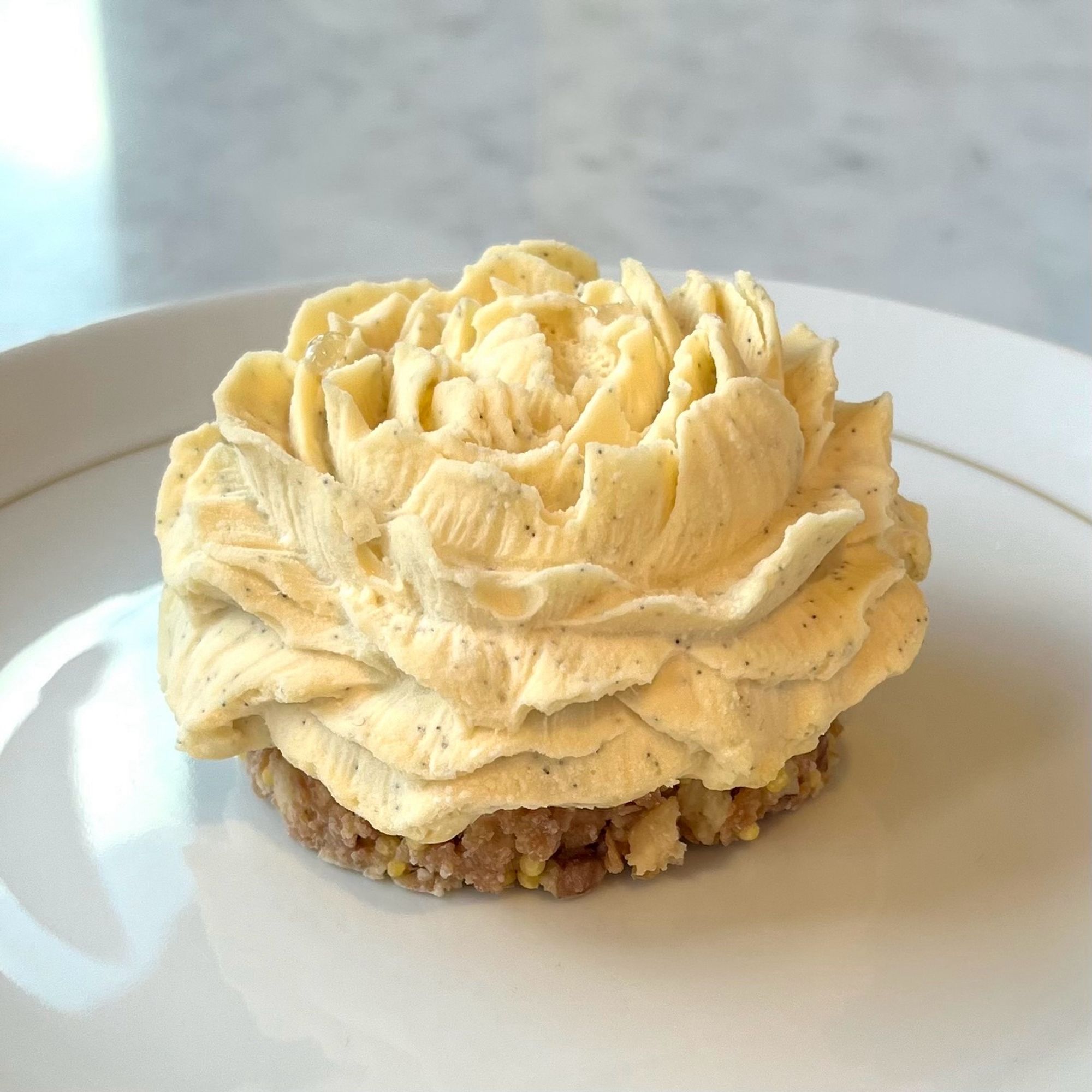 A delicious vanilla and pecan flower cake from Nina Metayer - it looks like a rose made from creamy frosting