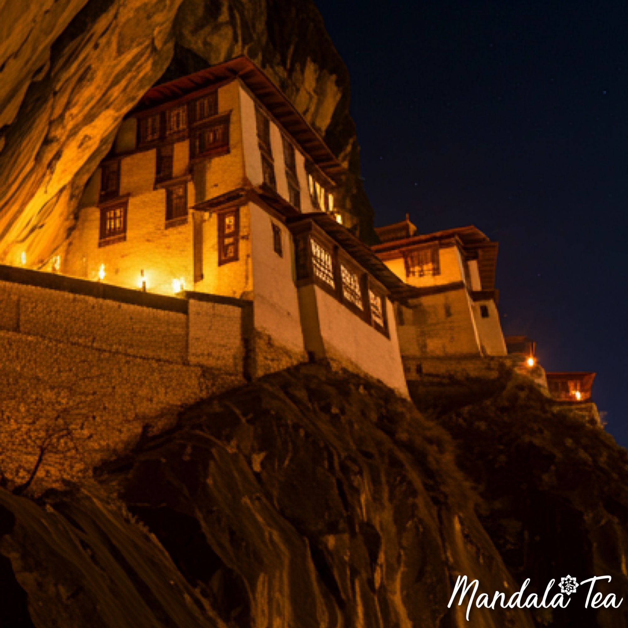 Image of a cliff side Buddhist monastery in China at night by candle and torch light.