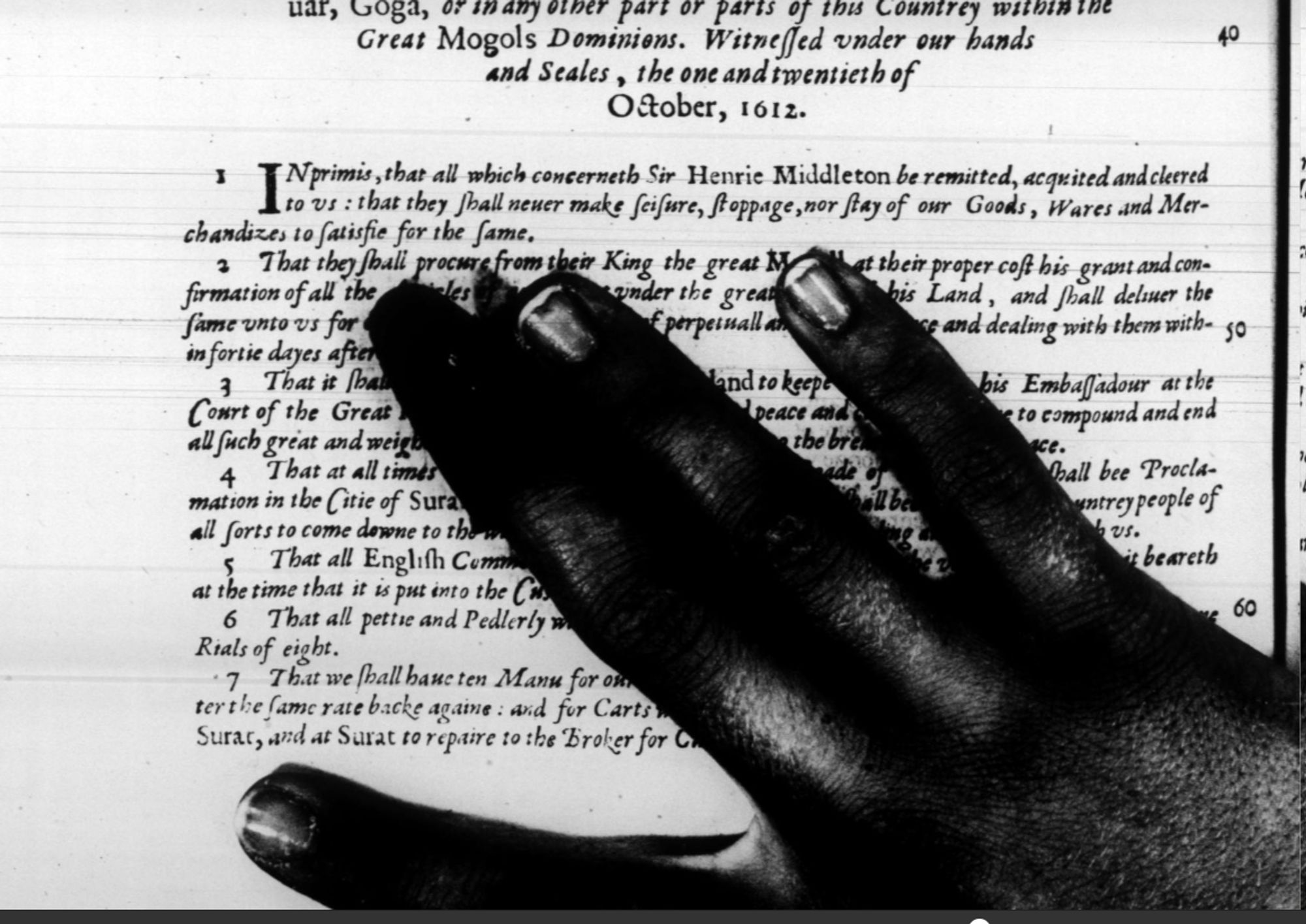 a hand totally obscuring the bottom of a page of a book that has been digitised