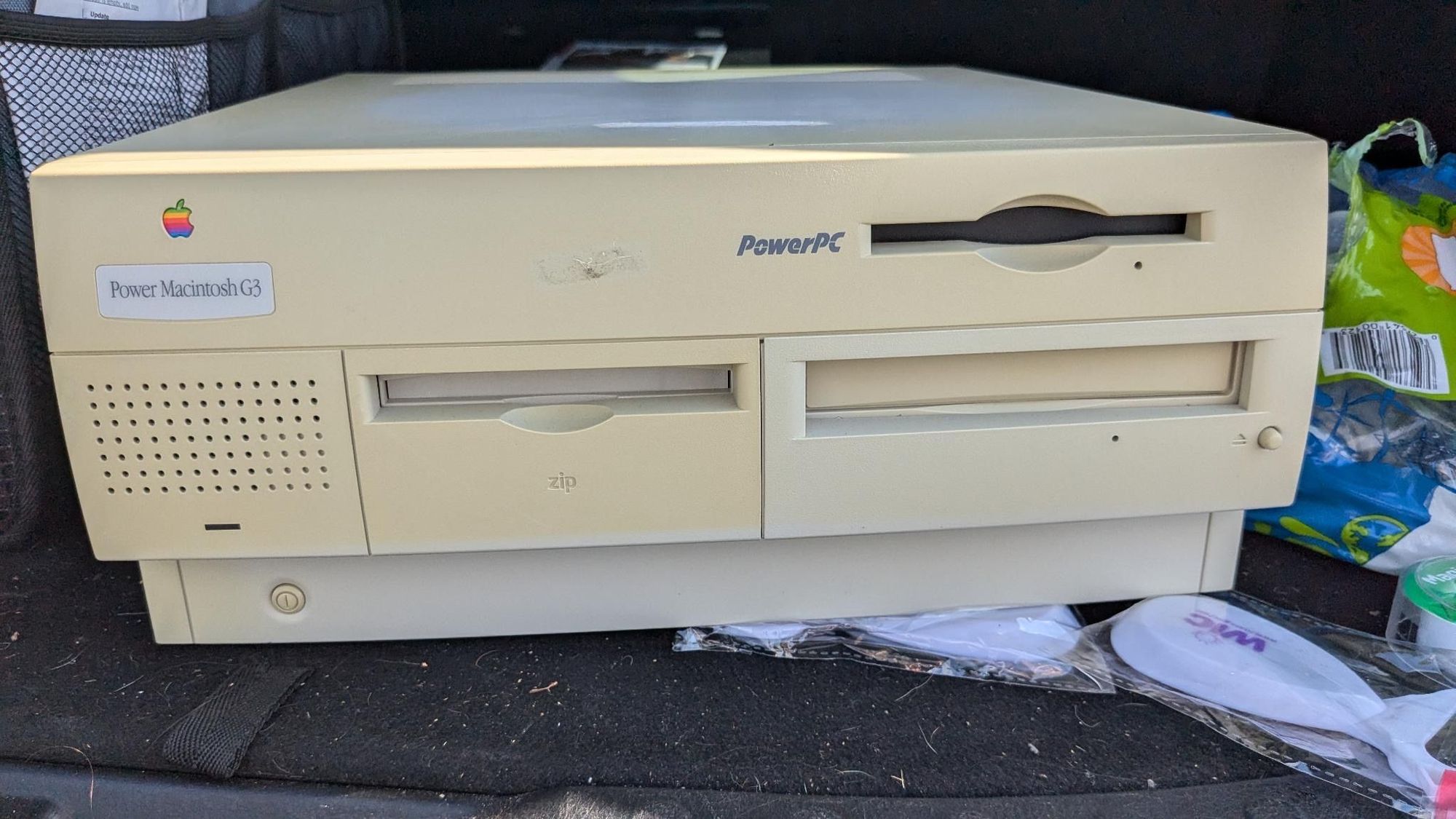 Power Macintosh G3 desktop with a built in Zip drive, slightly yellowed, sitting in the trunk of a suv. 