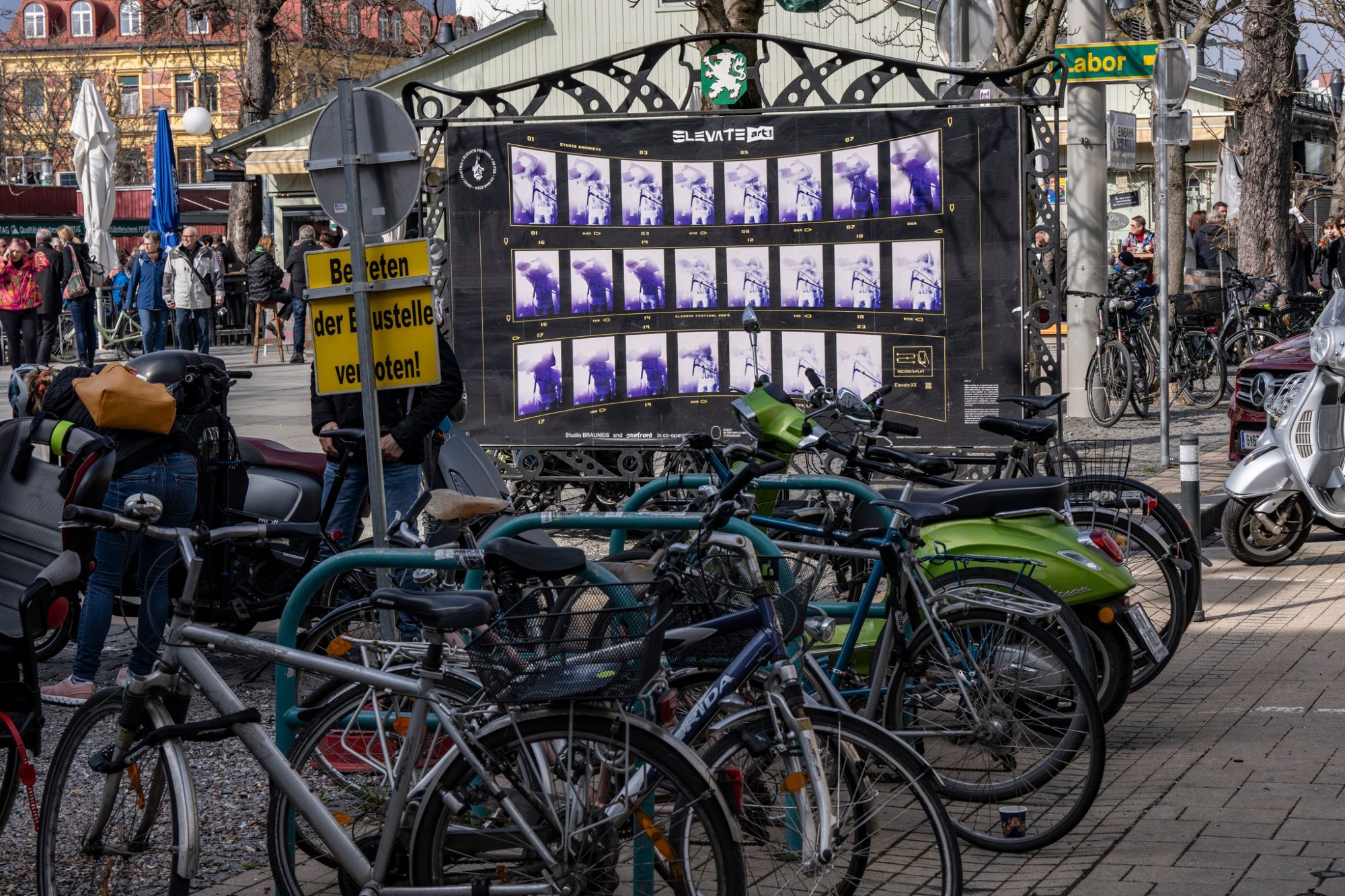 Selected film stills from Sebastian Brauneis' festival film are presented on historical city map panels in public urban space.