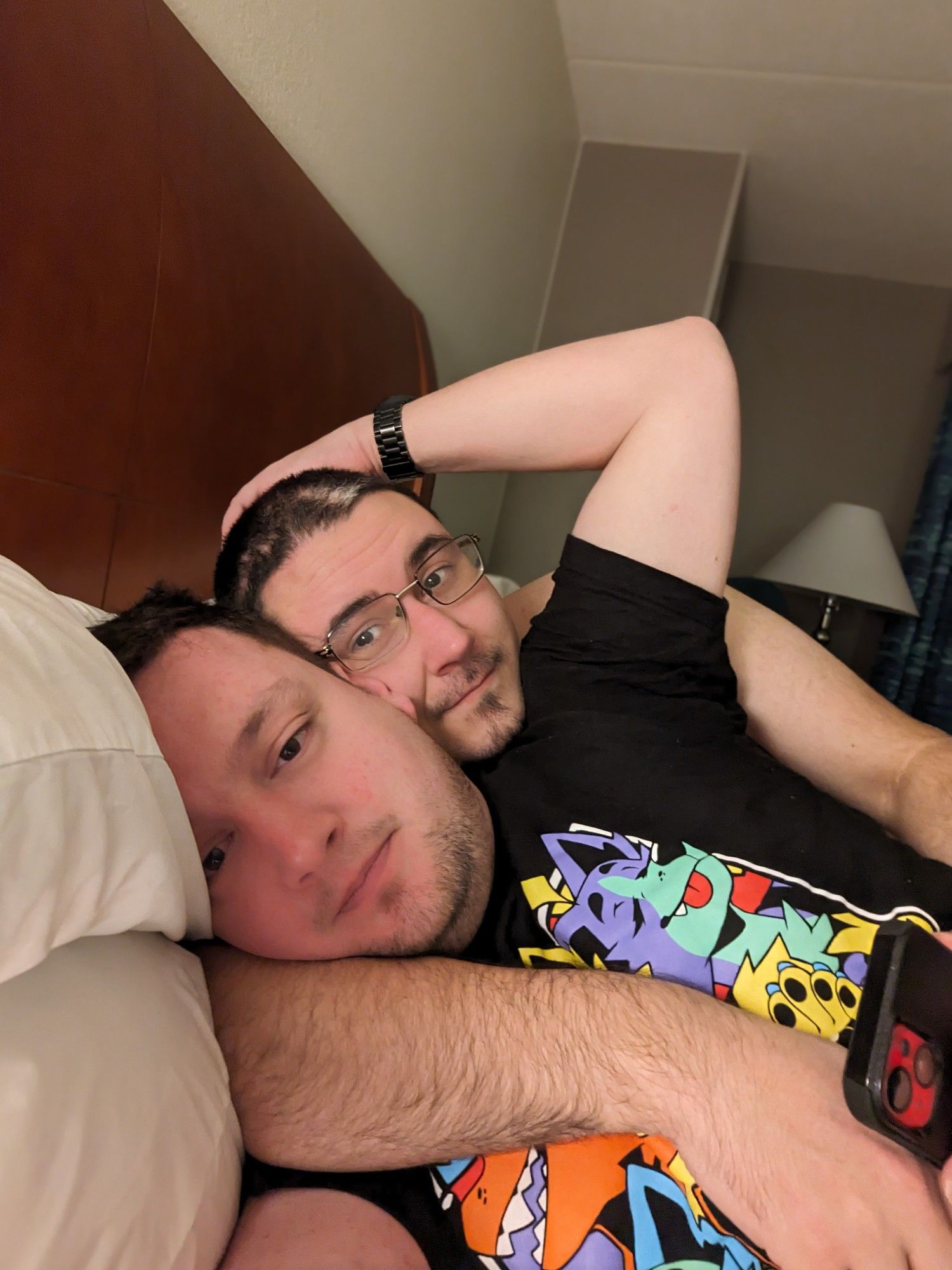 Grim and Volonos laying in bed at MFF 2023