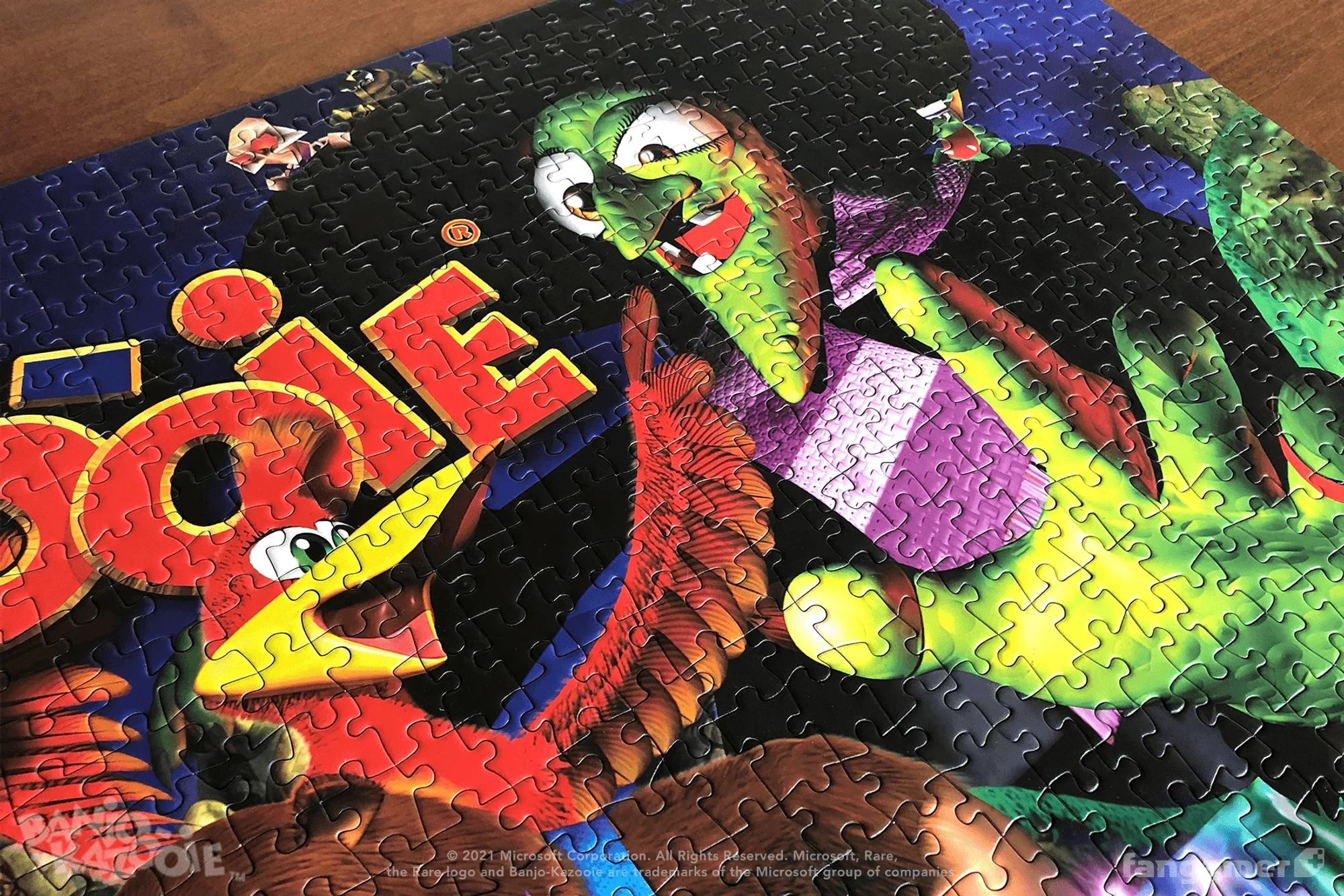 A jigsaw puzzle depicting the classic Banjo-Kazooie box art, photographed up close to show the pieces.