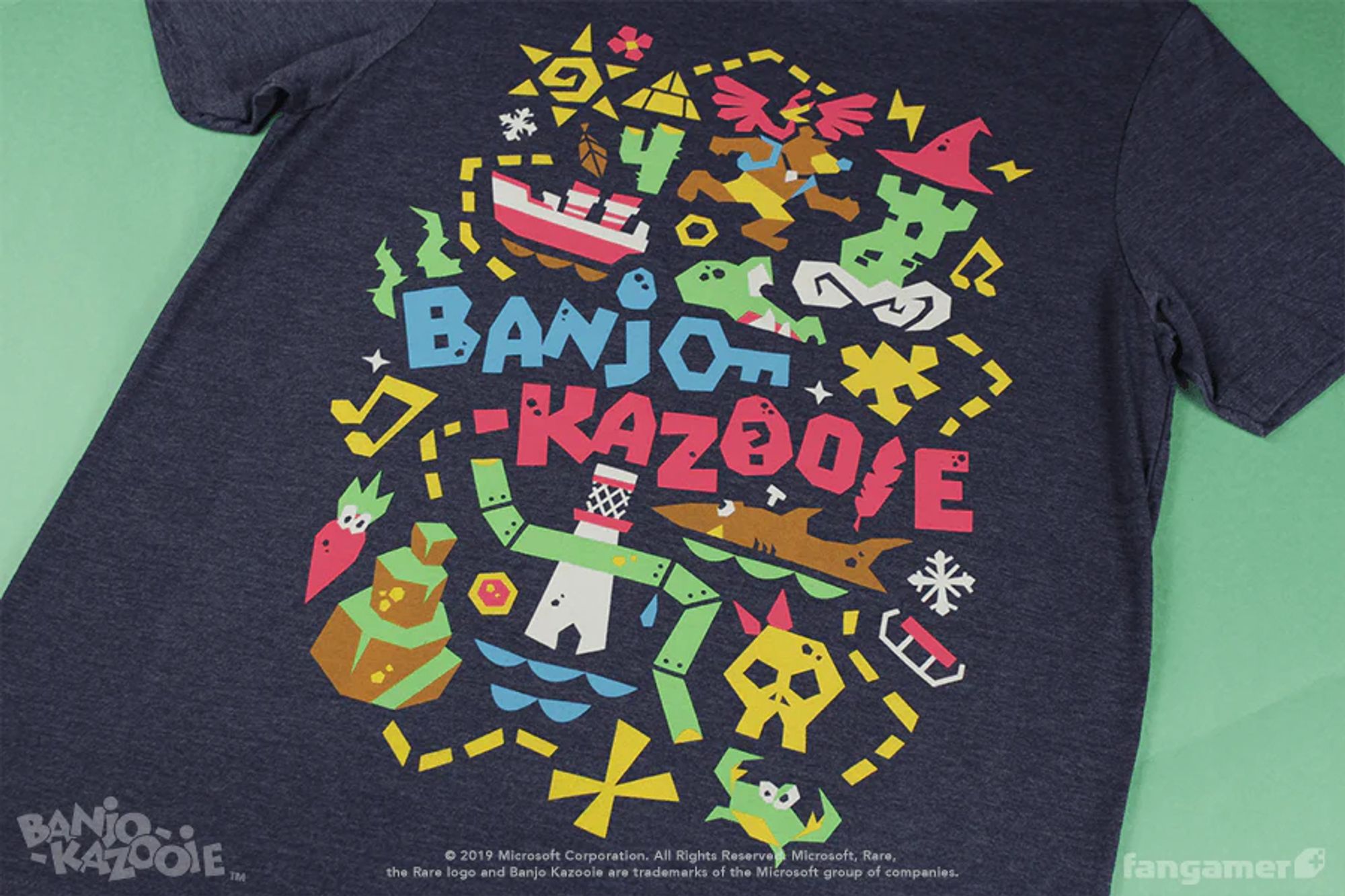 A navy Banjo-Kazooie shirt featuring the logo surrounded by simple, colorful shapes and paths related to the game.