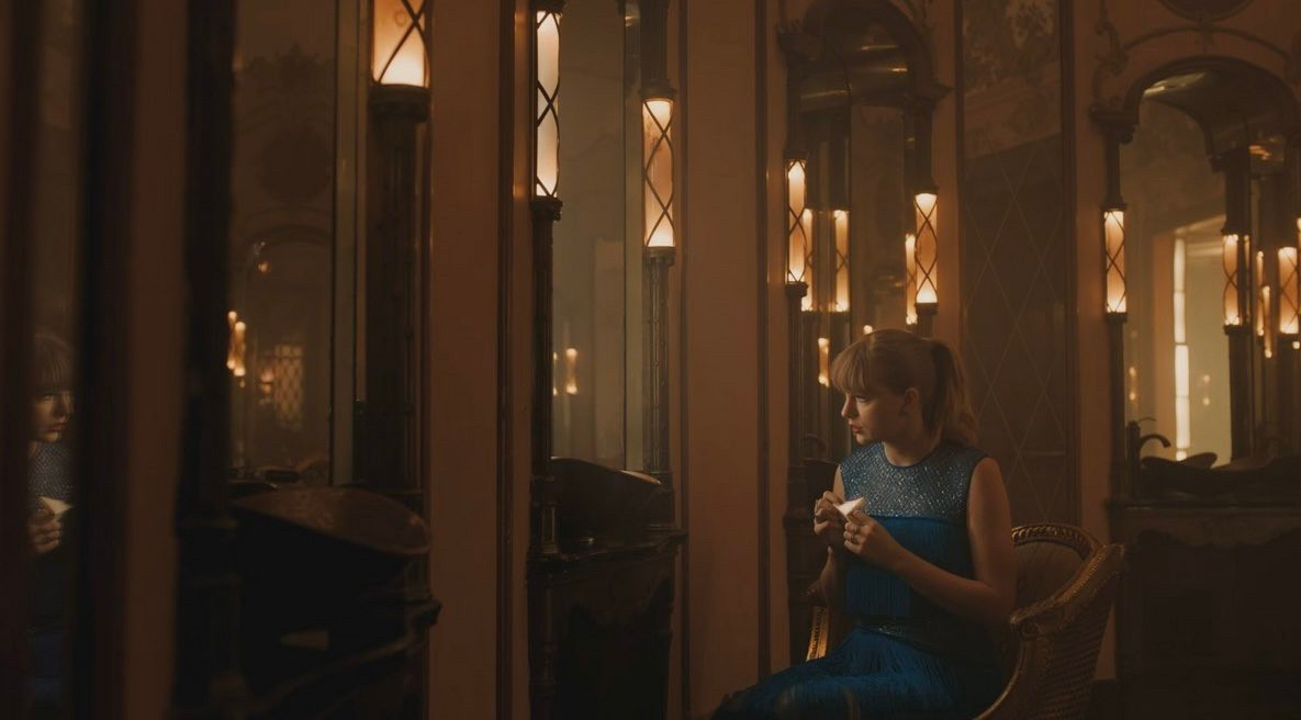 a screenshot of taylor swift from her delicate music video which was shot in the ladies cosmetics room at the Los Angeles theatre