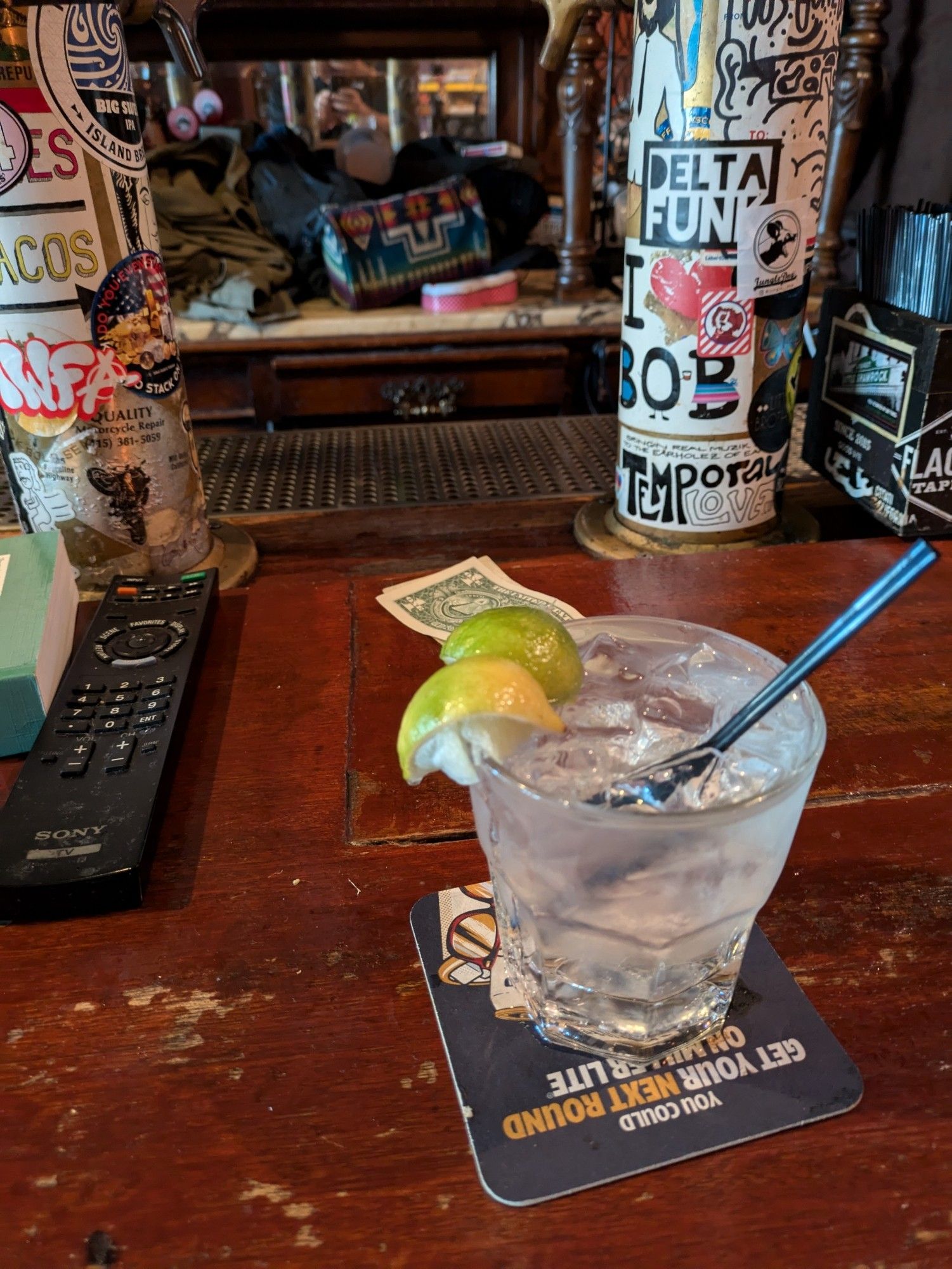 Gin and tonic, in the cool shadowy bar.