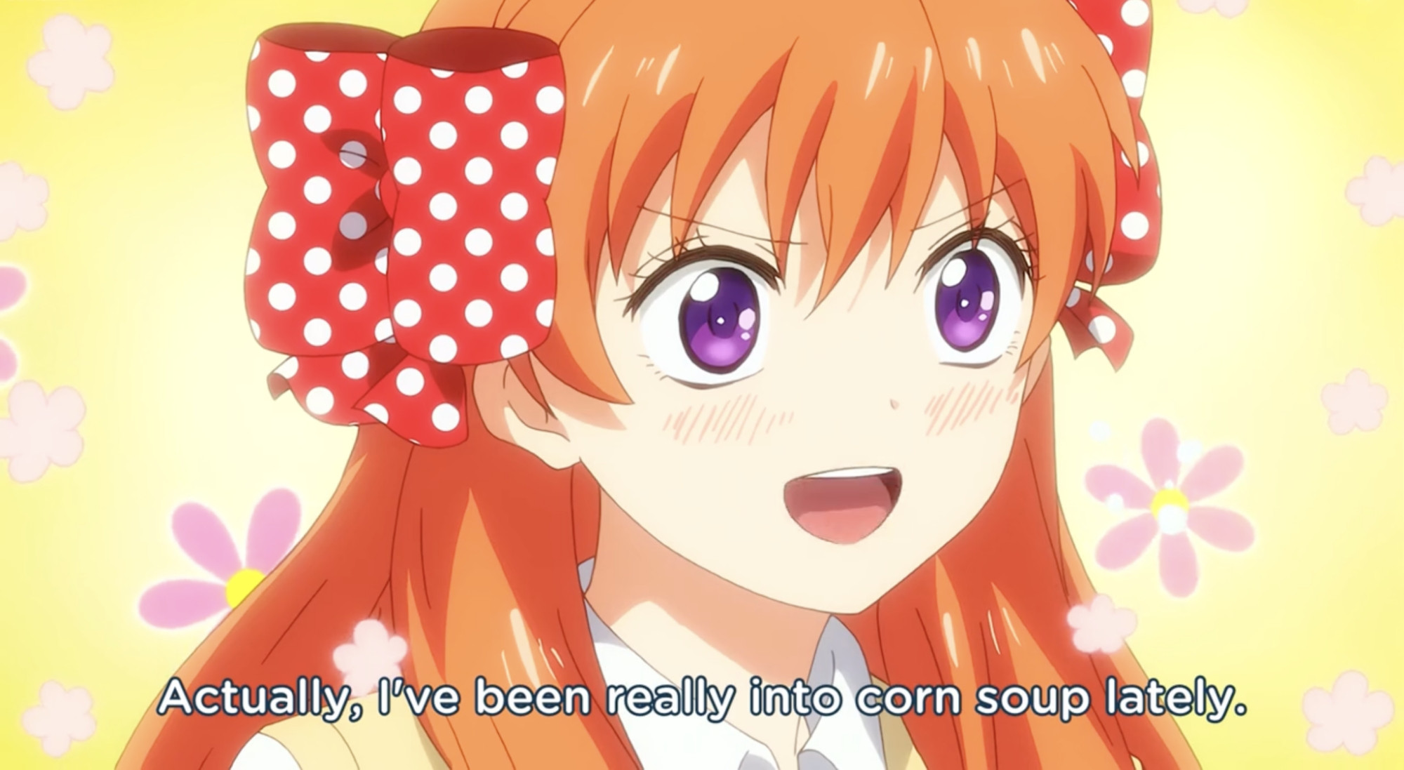 A screenshot of Chiyo Sakura, a girl with bright orange hair that has two red and white polkadot ribbons in it, from the anime Monthly Girls Nozaki-kun. She is saying "Actually, I've been really into corn soup lately."