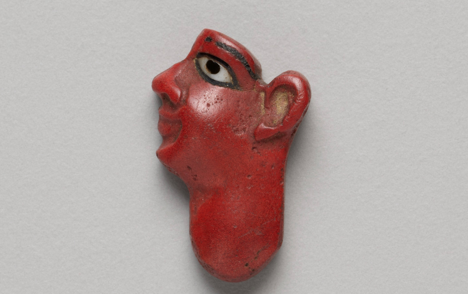 Inlay Depicting the Face of a KingDate:
Ptolemaic Period (332–30 BCE)

Artist:
Egyptian

About this artwork
Figures of the king or the gods made of pieces of brightly colored glass appeared about 1350 B.C. and continued to be made into the Ptolemaic period. The color follows the tradition in Egyptian art of depicting the skin of men as red.

Culture
Ancient Egyptian
Title
Inlay Depicting the Face of a King
Place
Egypt (Object made in:)
Date  
700 BCE–1 BCE
Medium
Glass
Dimensions
2 × 1.3 × 0.5 cm (3/4 × 1/2 × 3/16 in.)
Credit Line
Gift of Henry H. Getty, Charles L. Hutchinson, and Norman W. Harris
Reference Number
1892.170
IIIF Manifest  
https://api.artic.edu/api/v1/artworks/631/manifest.json
Extended information about this artwork
